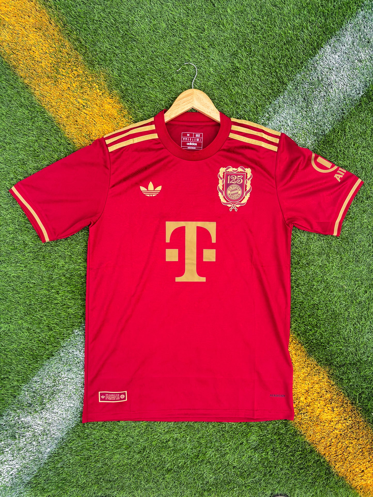 Front view of Bayern Munich 125th Anniversary vintage style jersey in red and white

