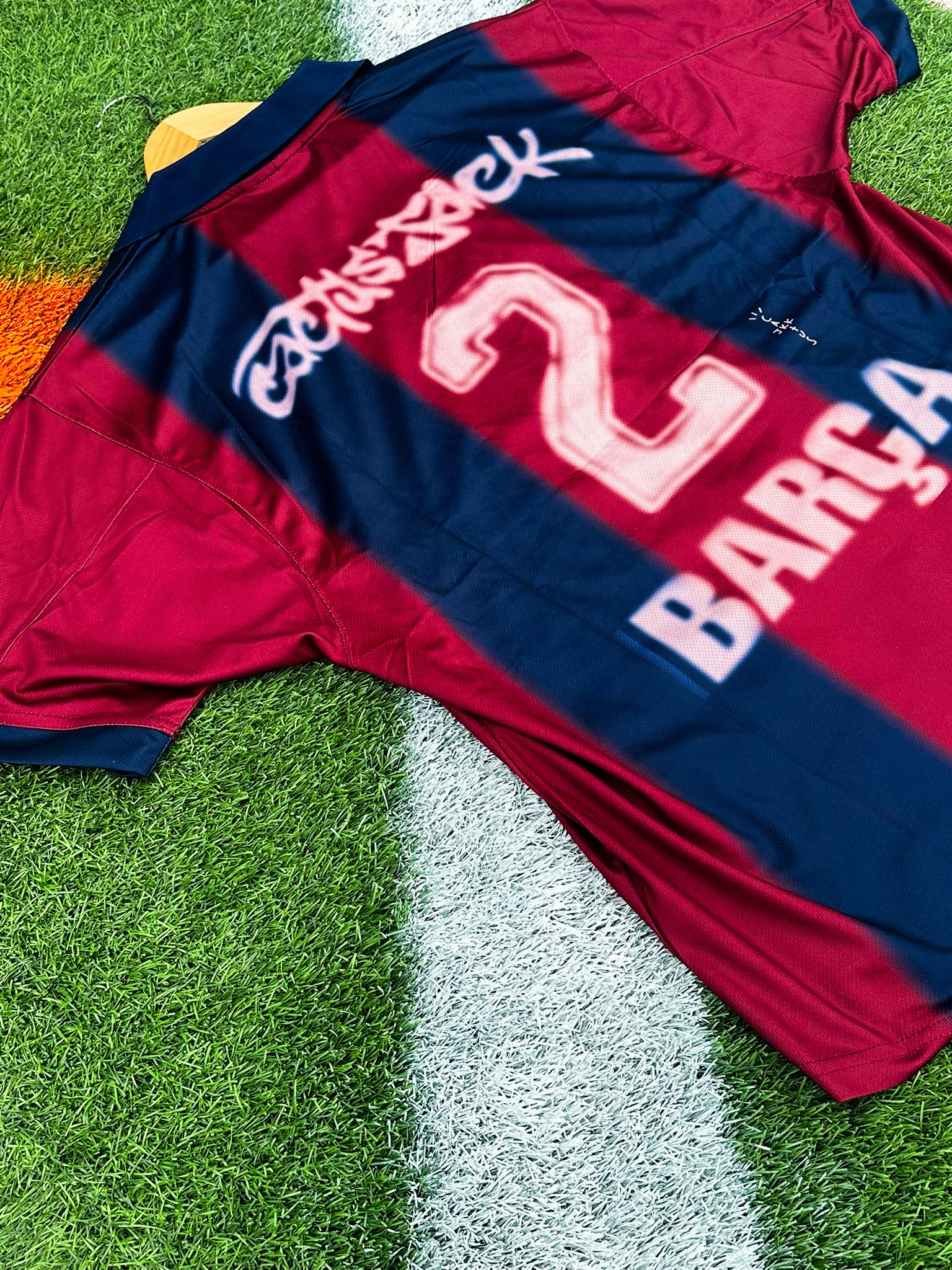 Close-up of Barcelona x Cactus Jack badge and Nike logo on 2024/2025 Home Jersey