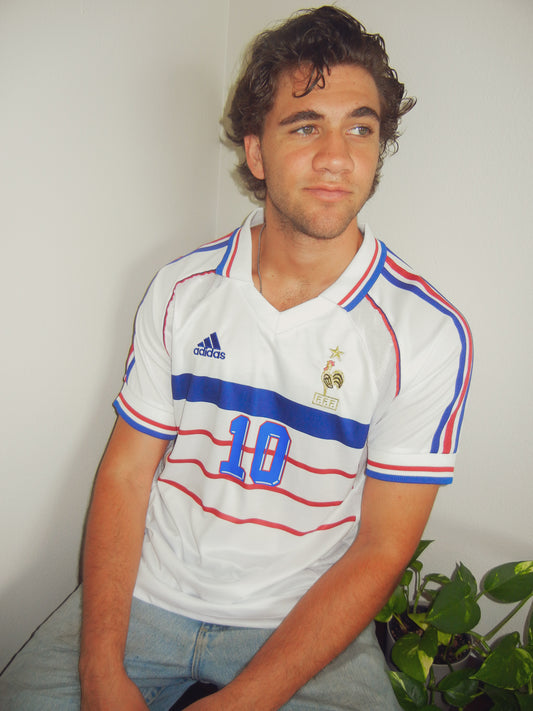 Styled look with the 1998 France away jersey paired with casual streetwear.

