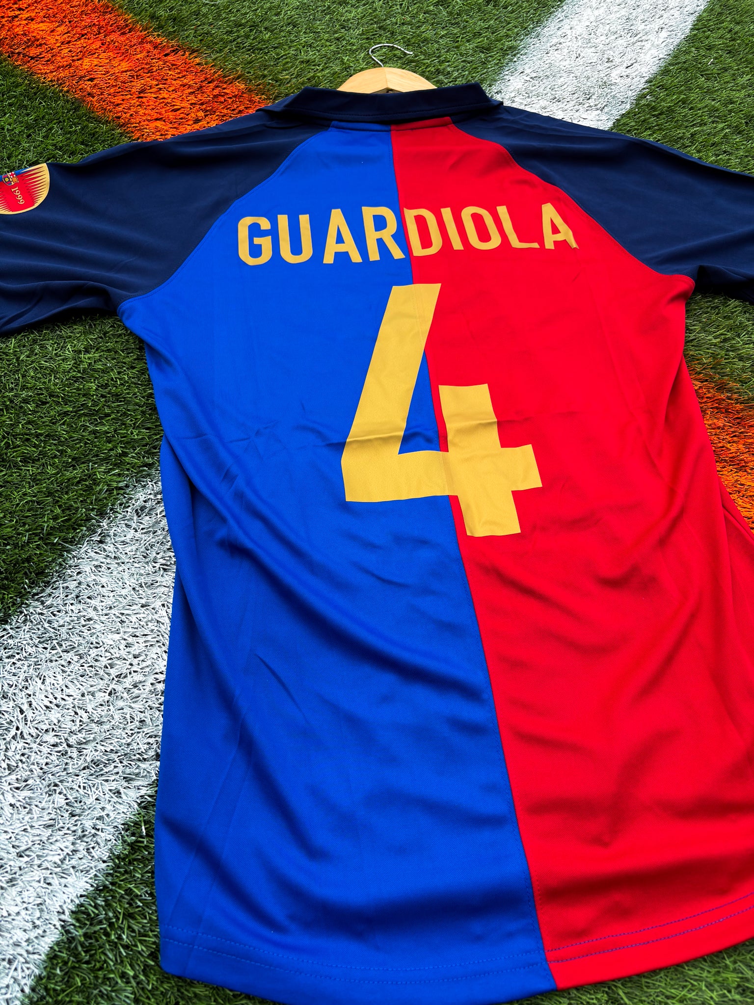 Back of the jersey showing classic red and blue stripes featuring guardiola #4

