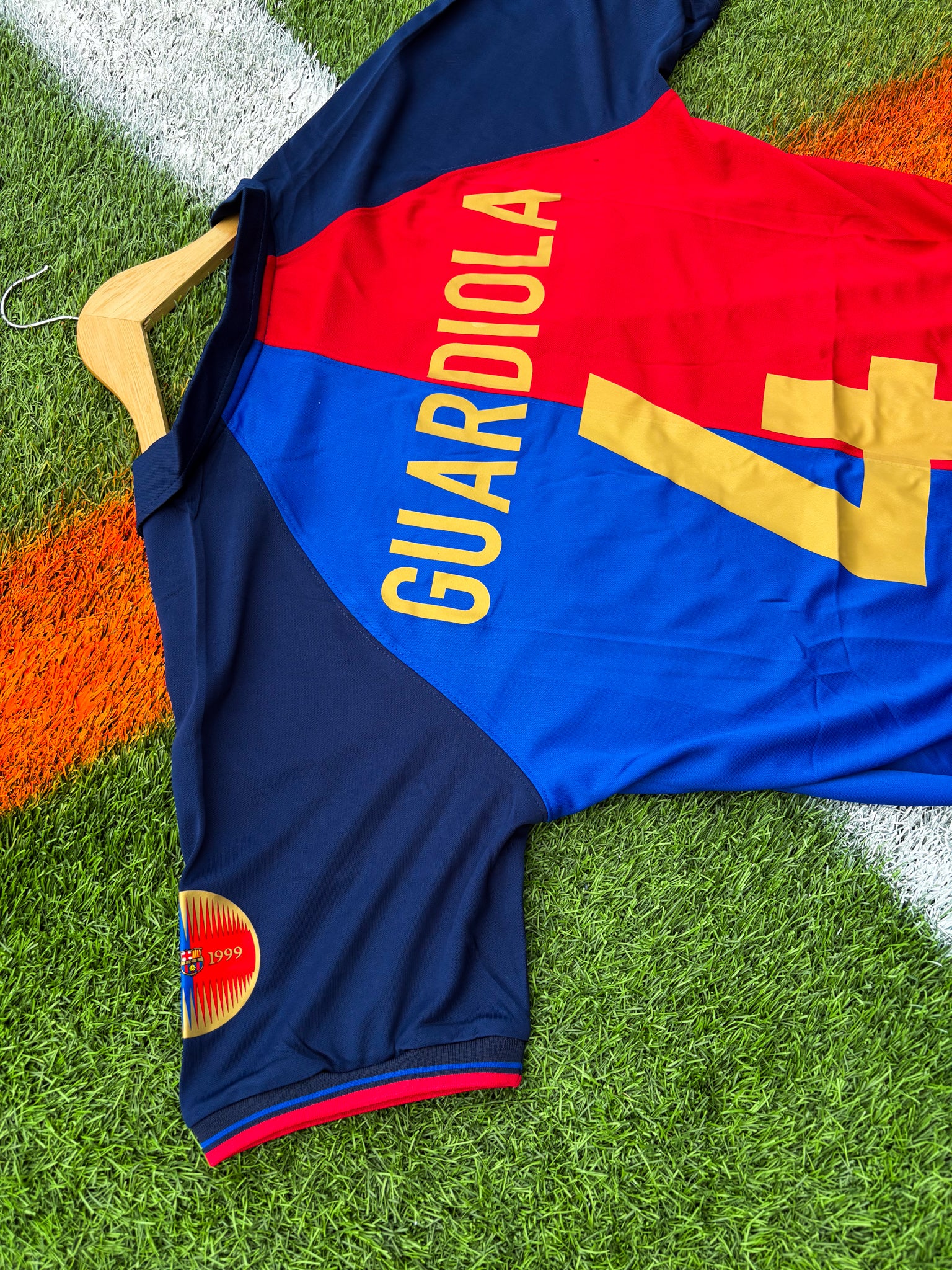 Back of the jersey showing classic red and blue stripes featuring guardiola #4

