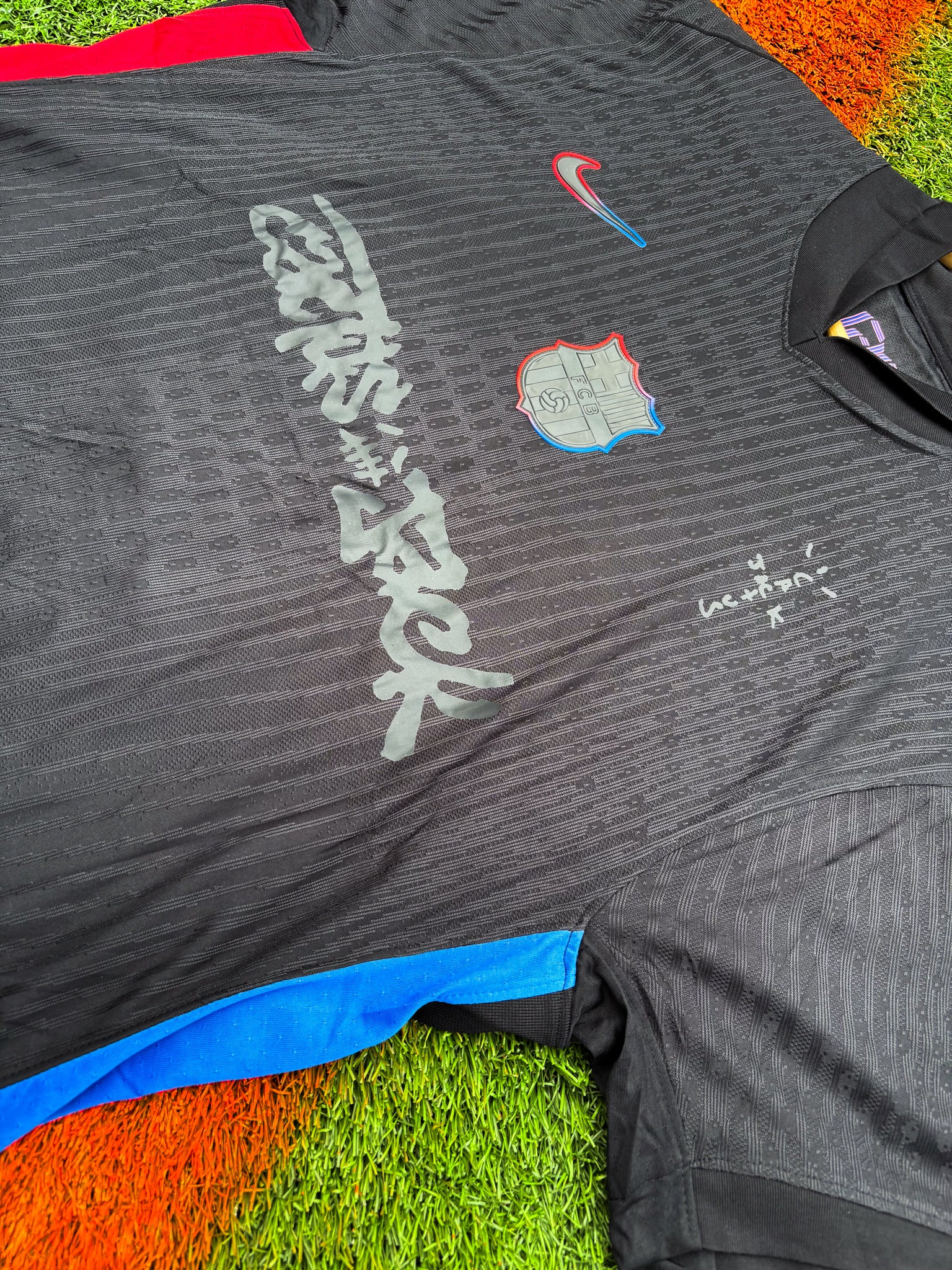 Close-up of fabric texture and embroidered crest, reminiscent of premium Cactus Jack merch styling
