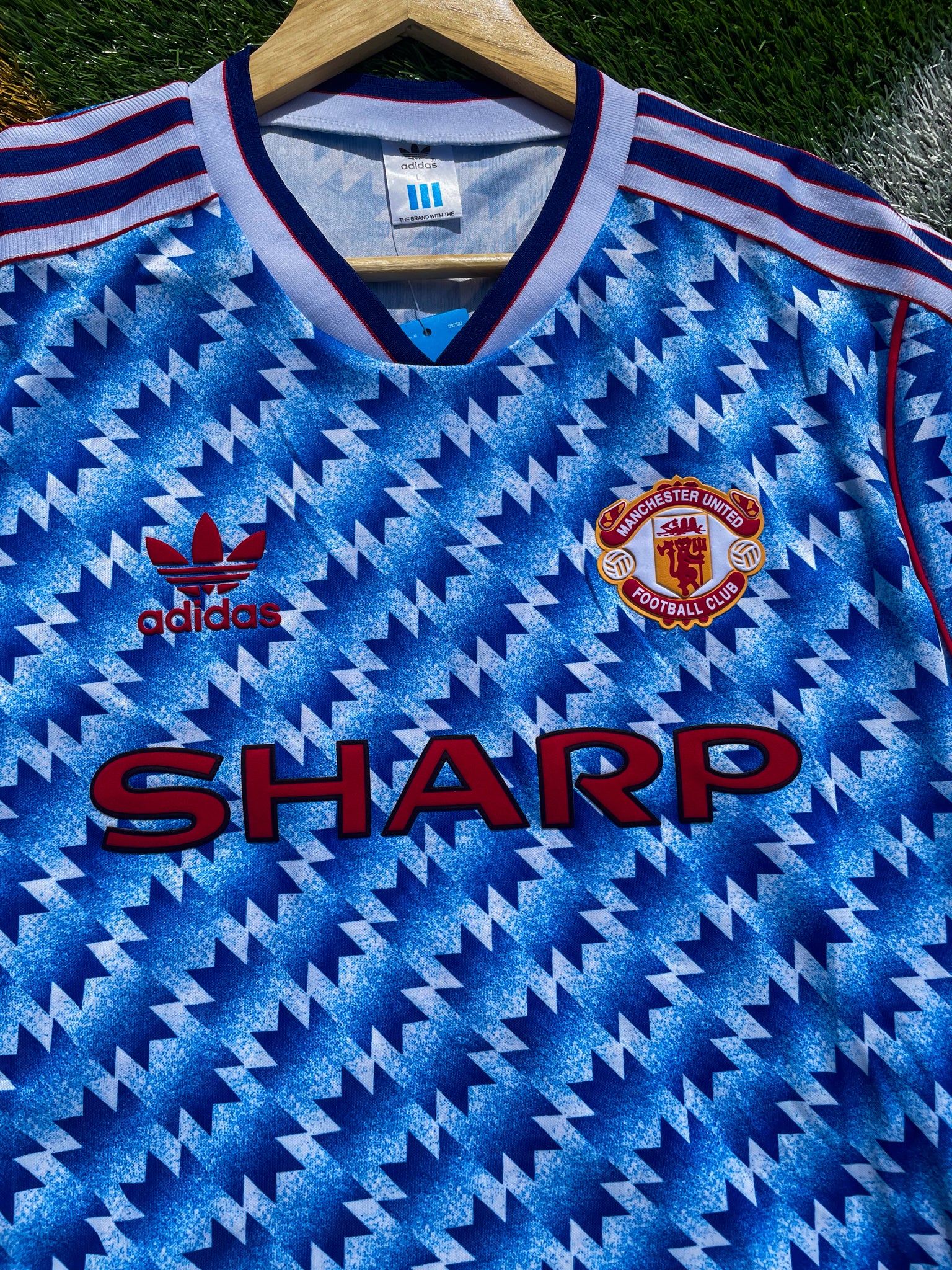Close-up view of the vintage Adidas jersey design

