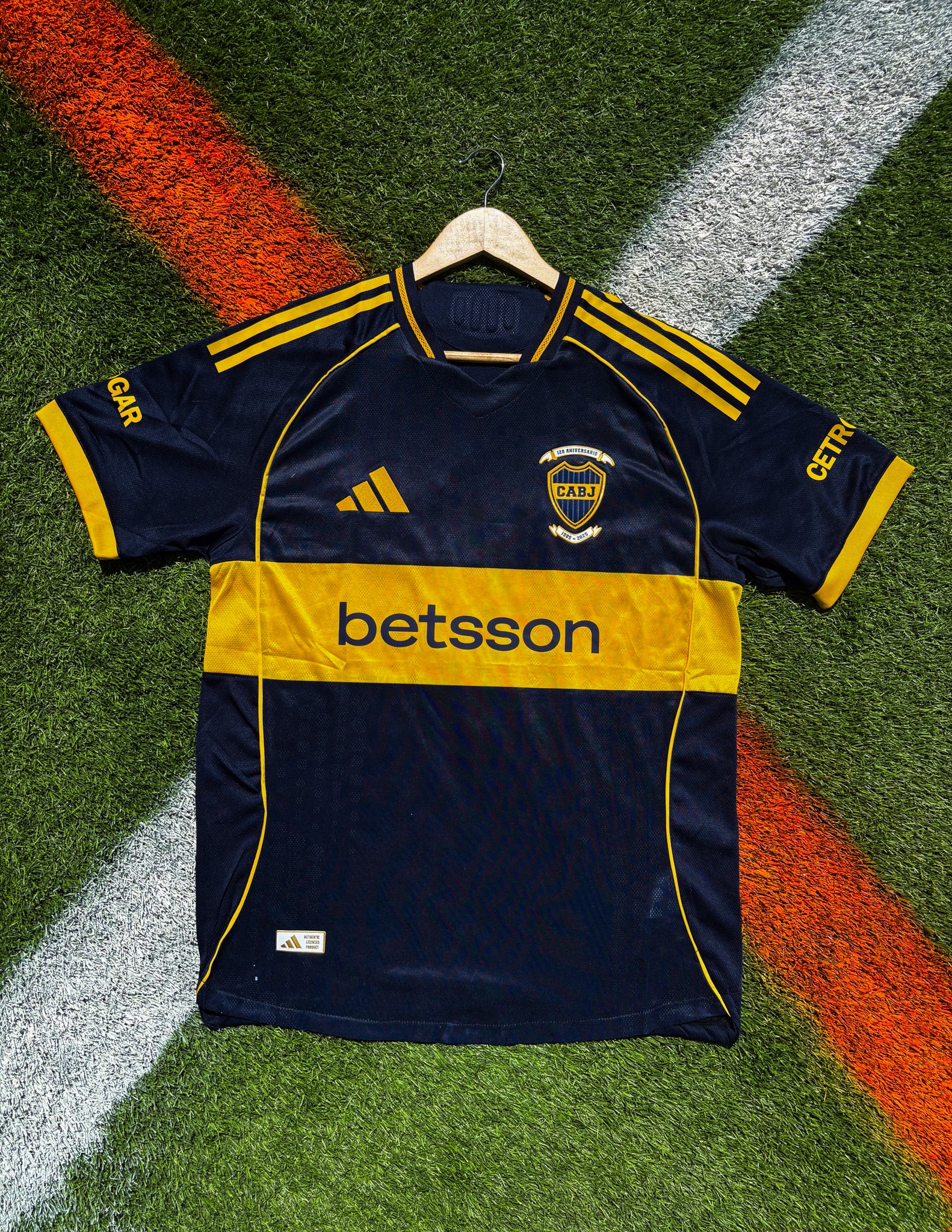 Front view of Boca Juniors 2025–26 home jersey in deep navy with gold chest stripe
