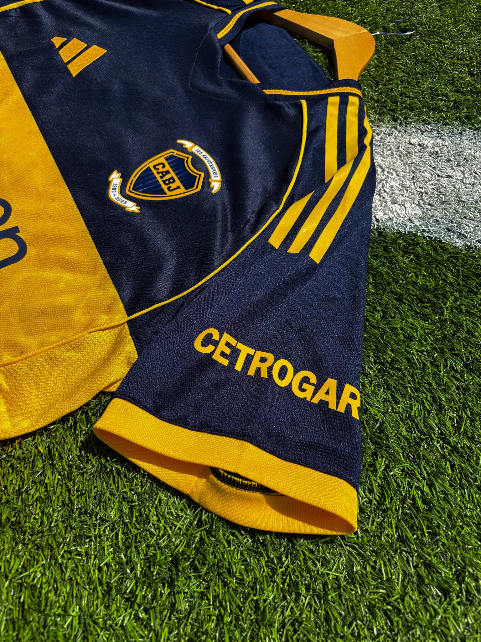 side view of Boca Juniors 2025–26 home jersey in deep navy with gold chest stripe