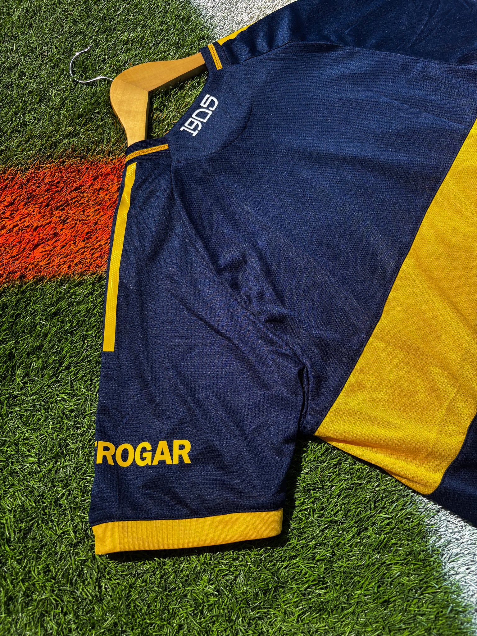 Back side view of Boca Juniors 2025–26 home jersey in deep navy with gold chest stripe