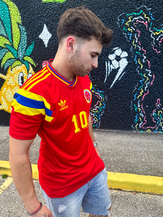 Model styling the Colombia 1990 Away Jersey in a retro streetwear look