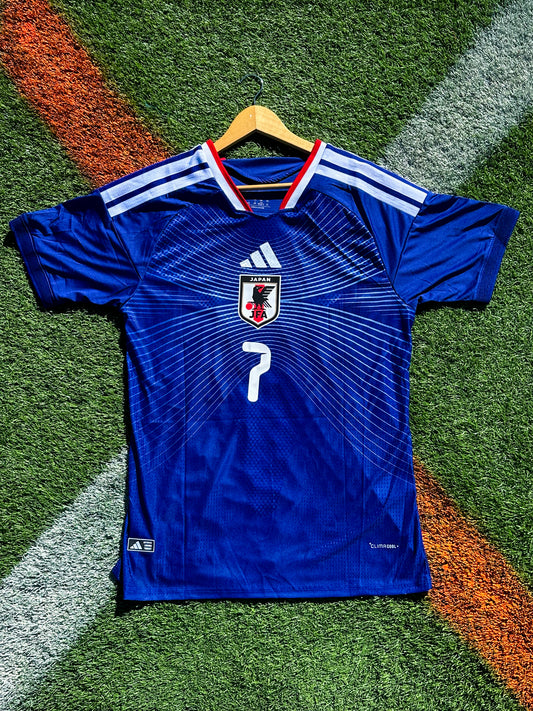 Blue sports jersey with a logo and number on a grass field
