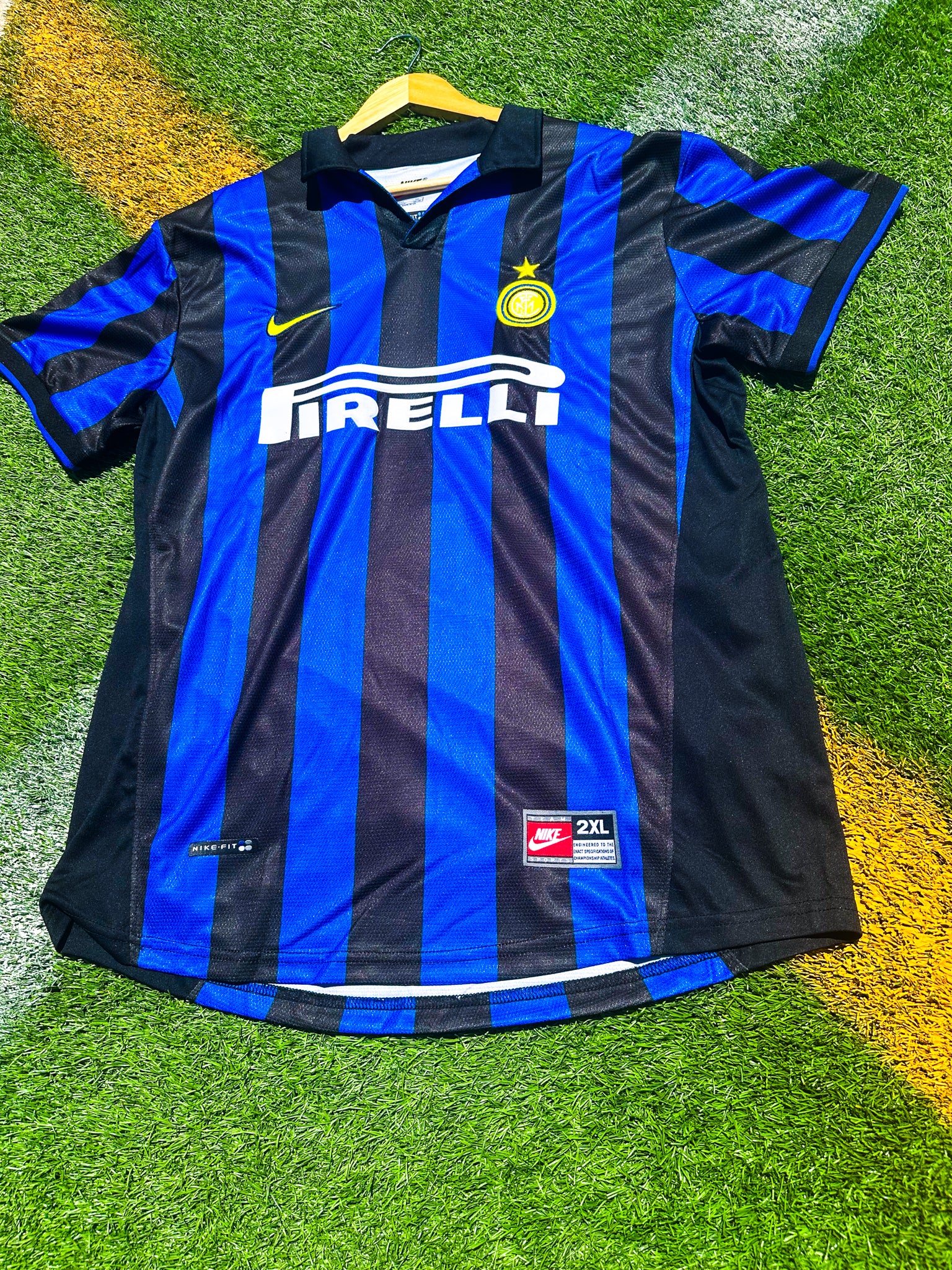Detailed close-up of Inter crest, Umbro logo, and collar design.