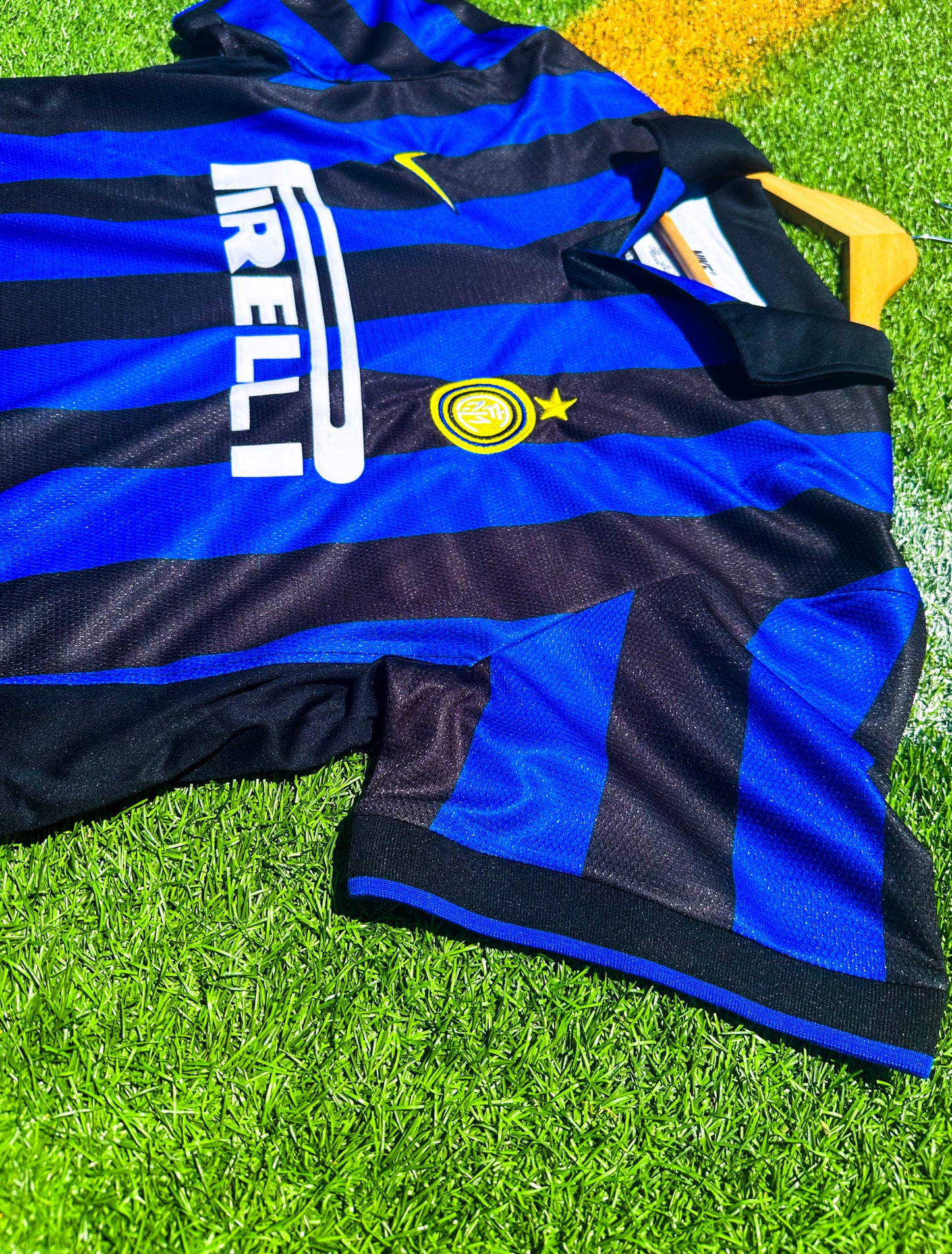 Detailed close-up of Inter crest, Umbro logo, and collar design.