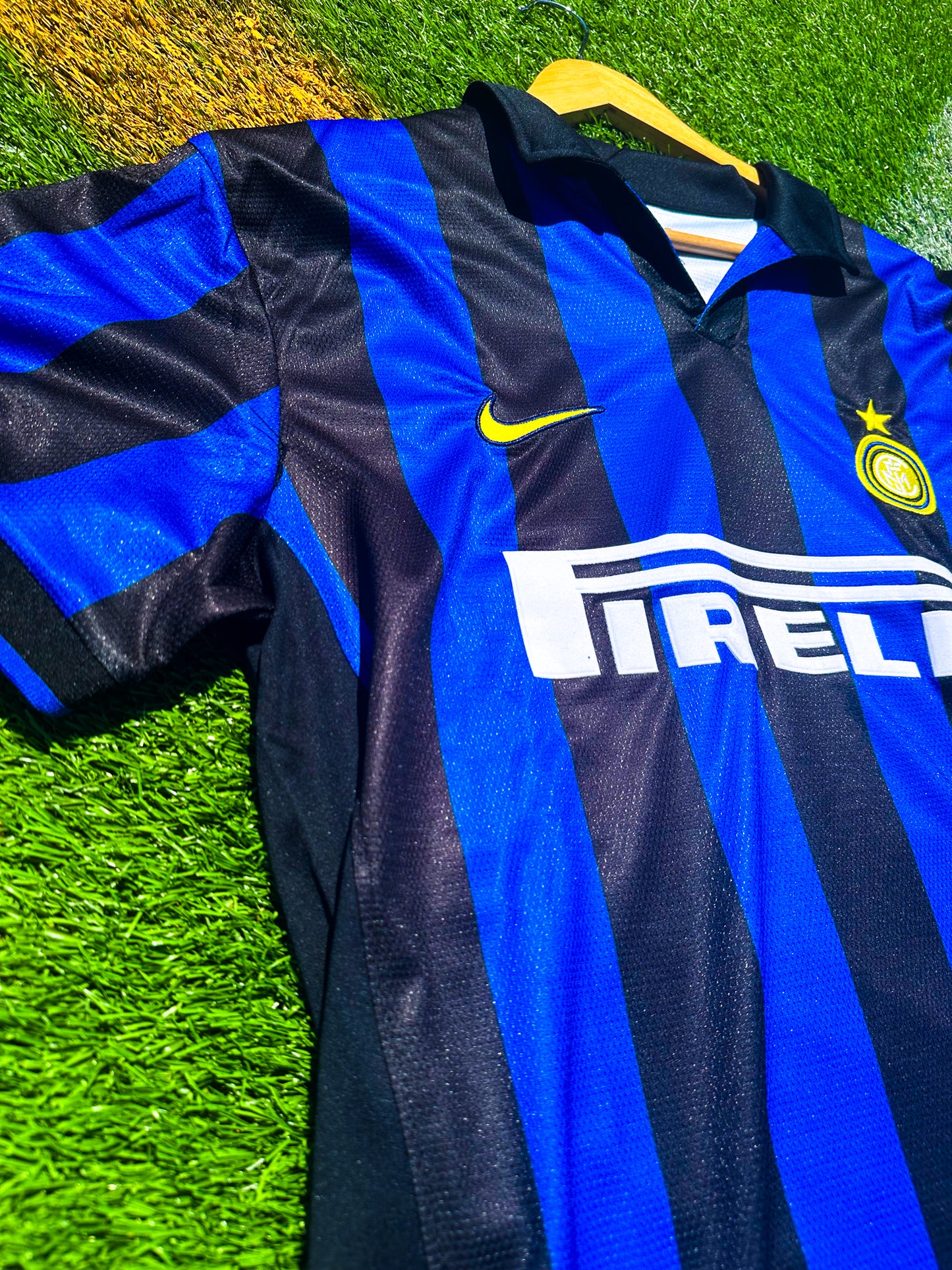 Detailed close-up of Inter crest, Umbro logo, and collar design.