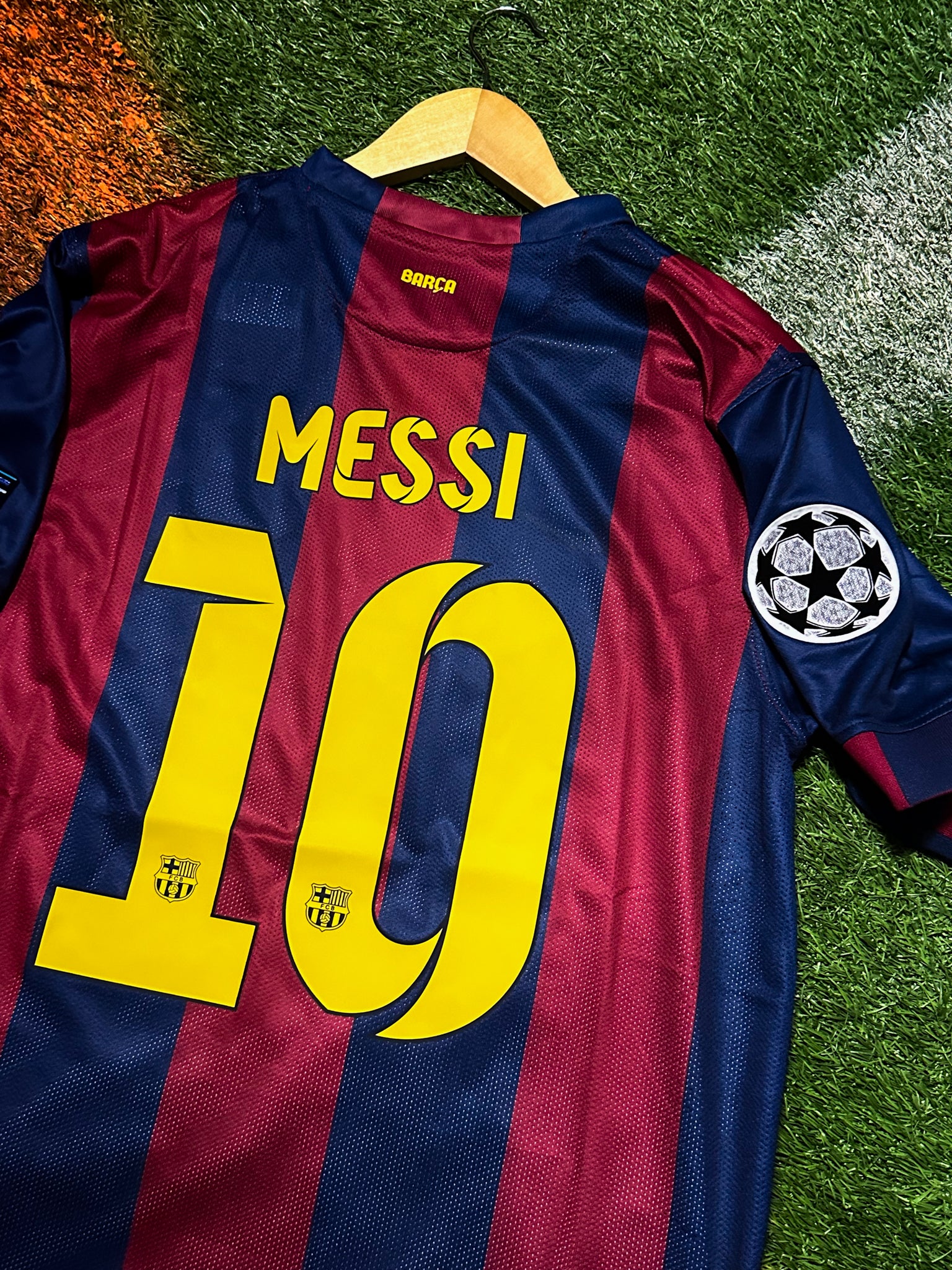 FC Barcelona 2014-15 home jersey with Messi #10, red and blue stripes, Champions League patch.