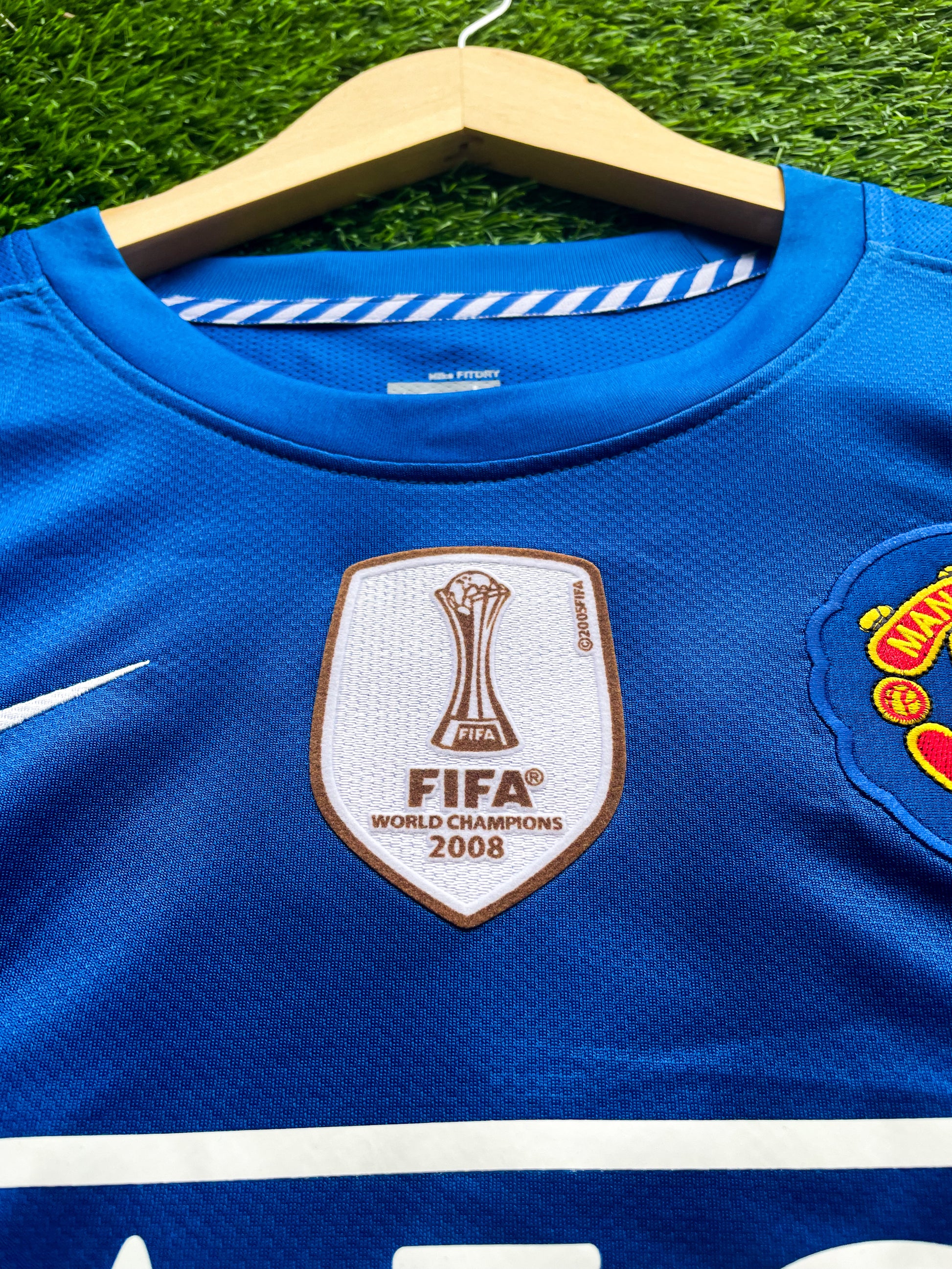Close-up of Nike logo and Manchester United crest

