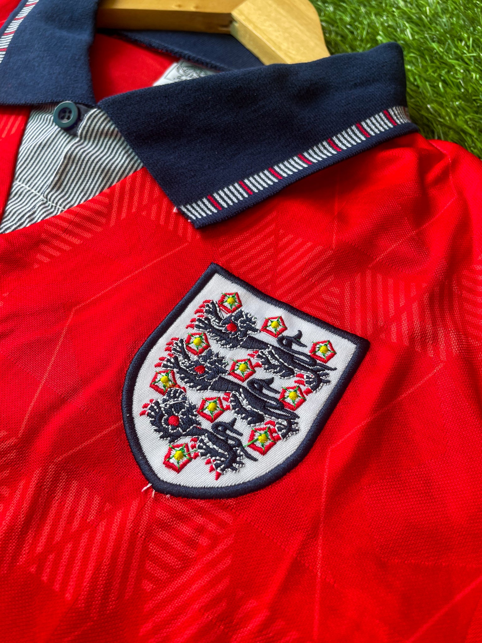 Close-up of Umbro logo and geometric pattern.

