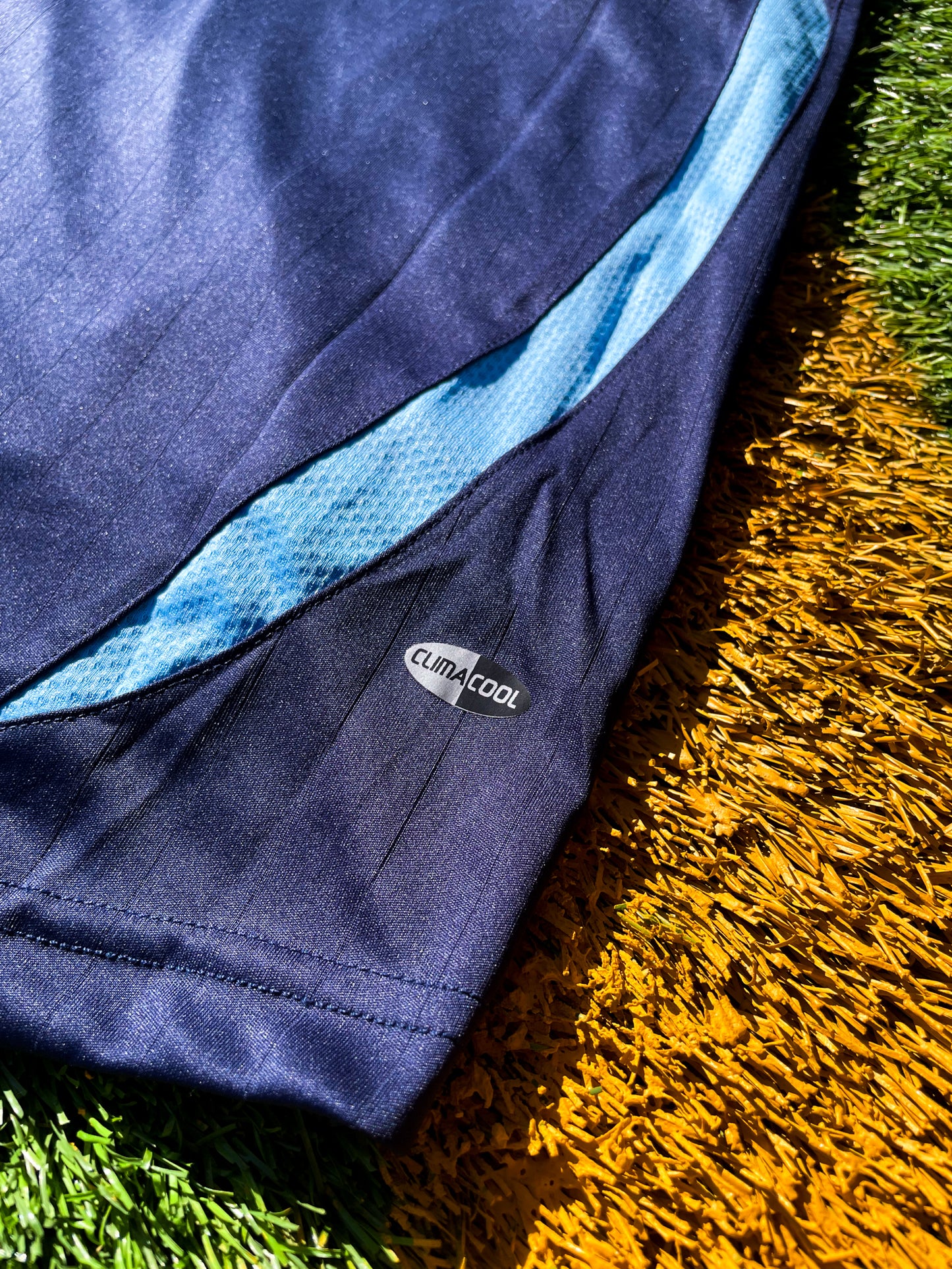 Detailed shot of the jersey's fabric texture and sky blue accents.