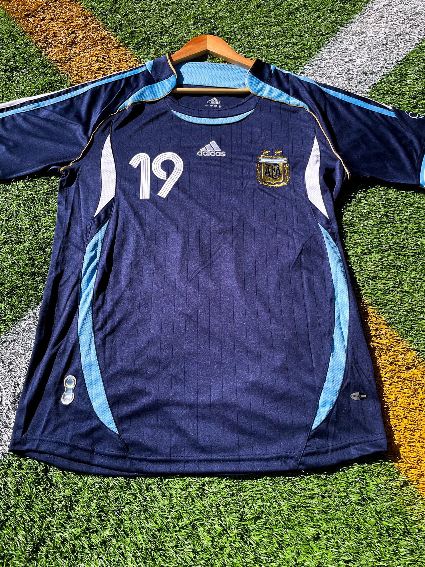 Front view of Argentina 2006 Away Jersey with Messi #19 and AFA crest.