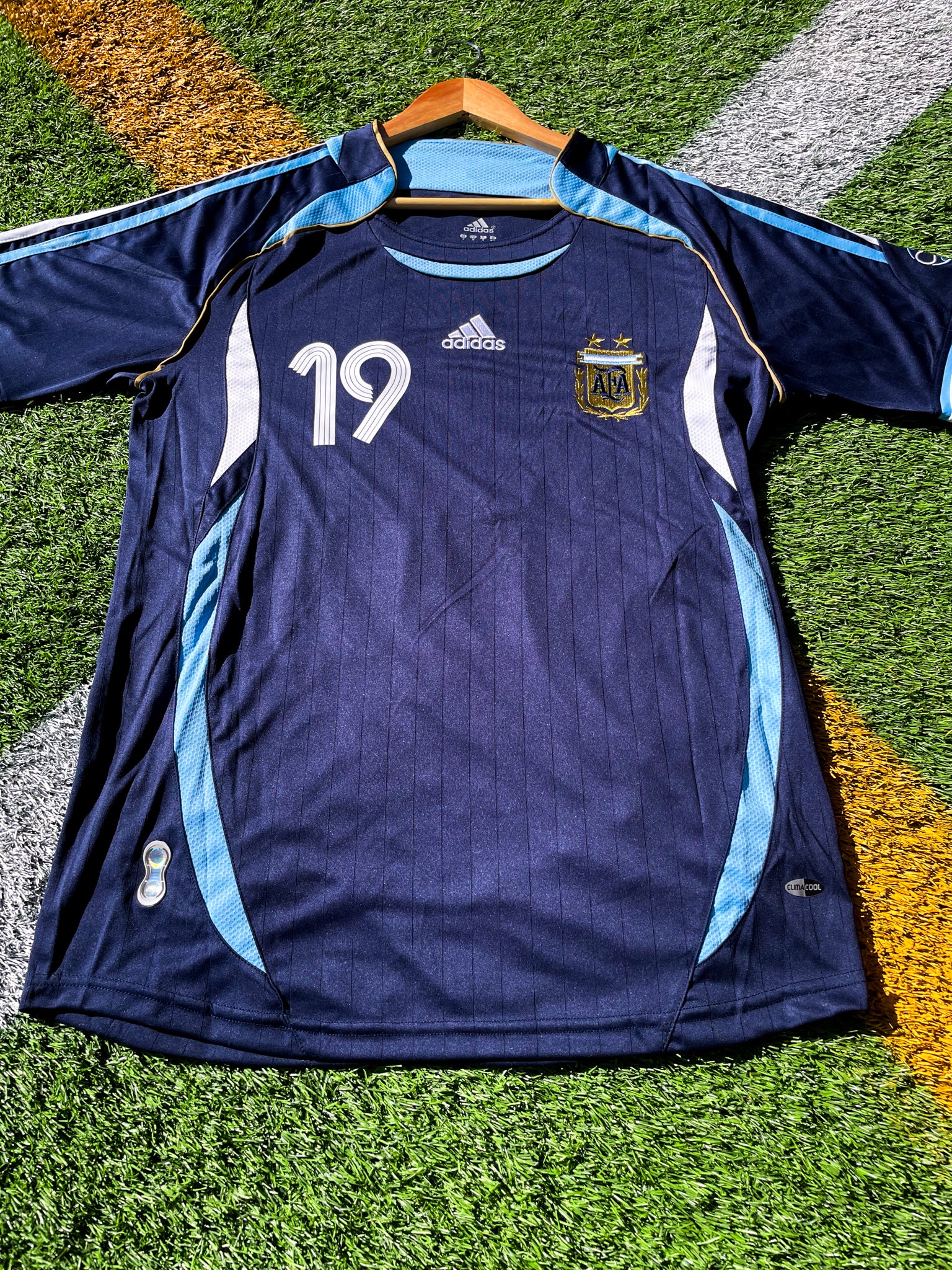 Front view of Argentina 2006 Away Jersey with Messi #19 and AFA crest.