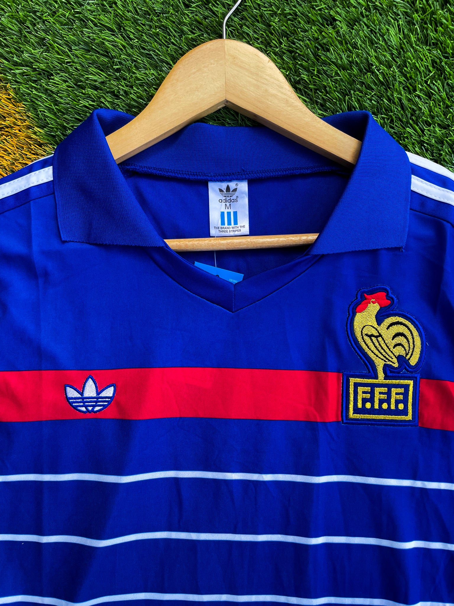 Close-up of FFF crest and Adidas trefoil on the jersey


