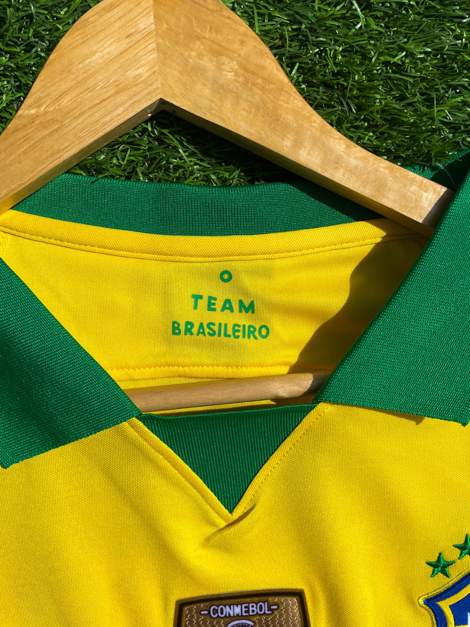 Close-up of green collar and Nike swoosh on retro jersey