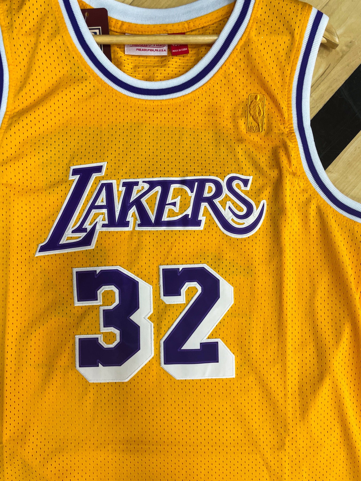 Close-up of Lakers logo and mesh fabric details with gold trim


