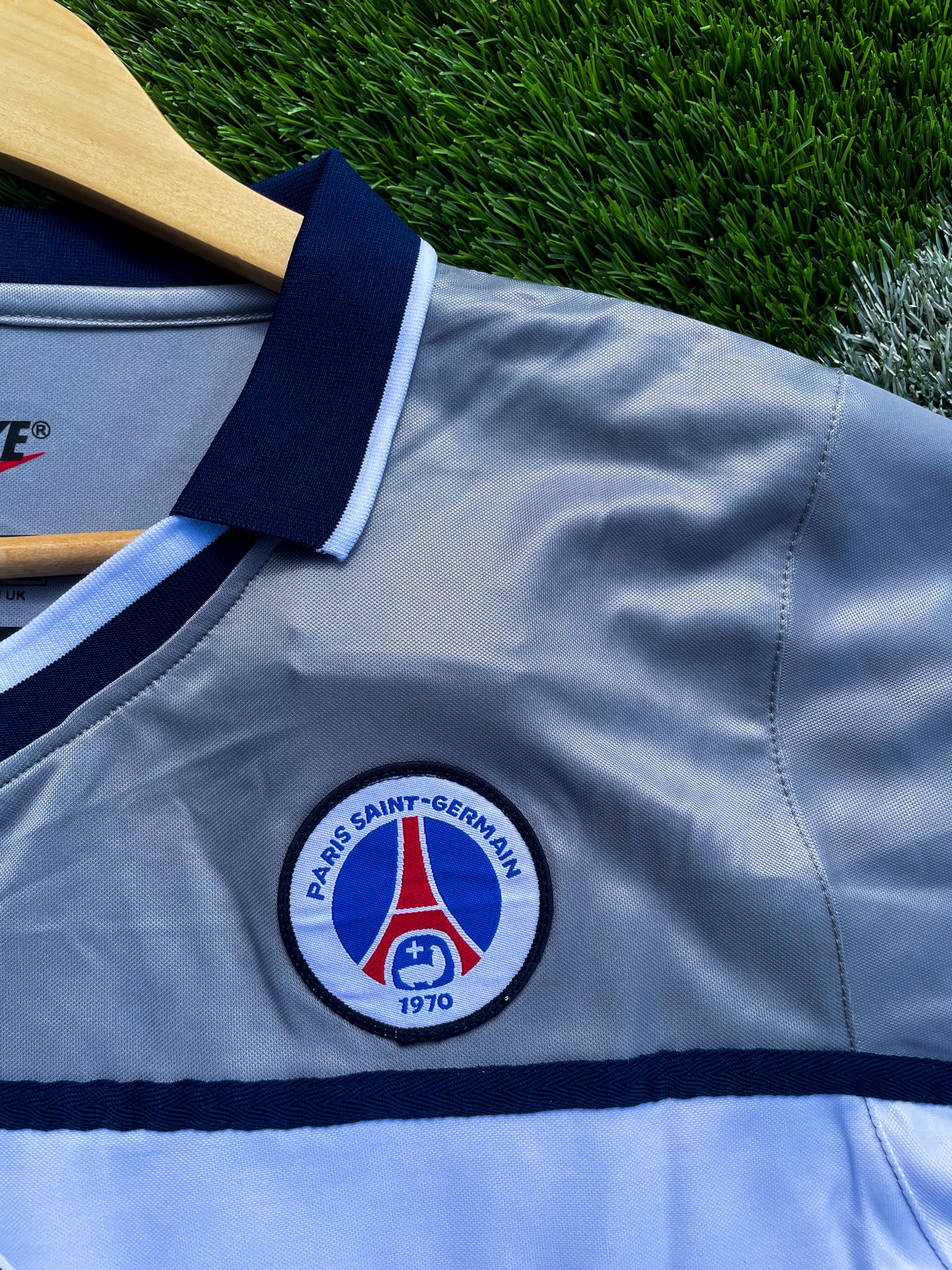 Close-up of vintage PSG crest and Opel sponsor

