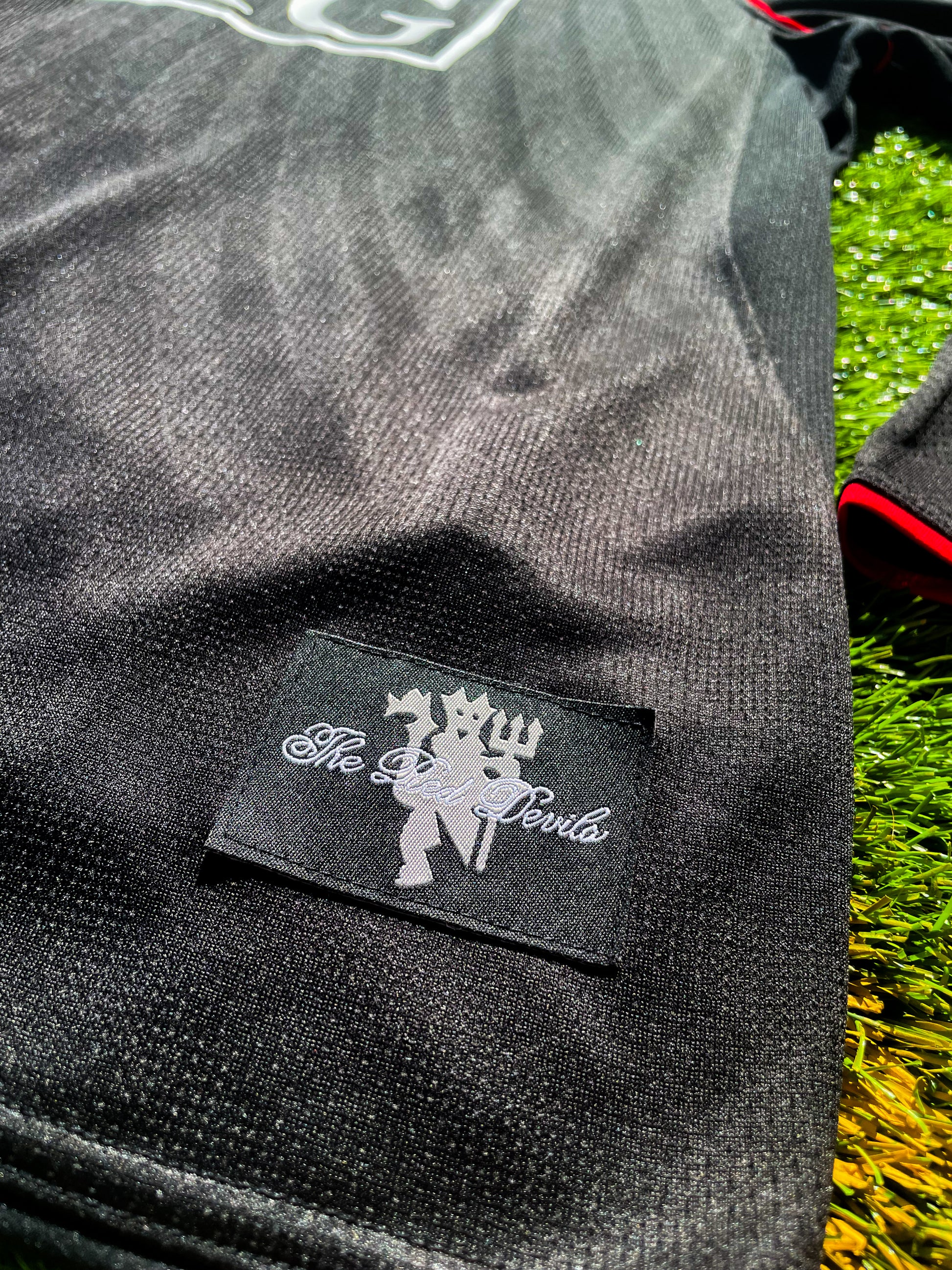 Close-up of gold Nike logo and club crest

