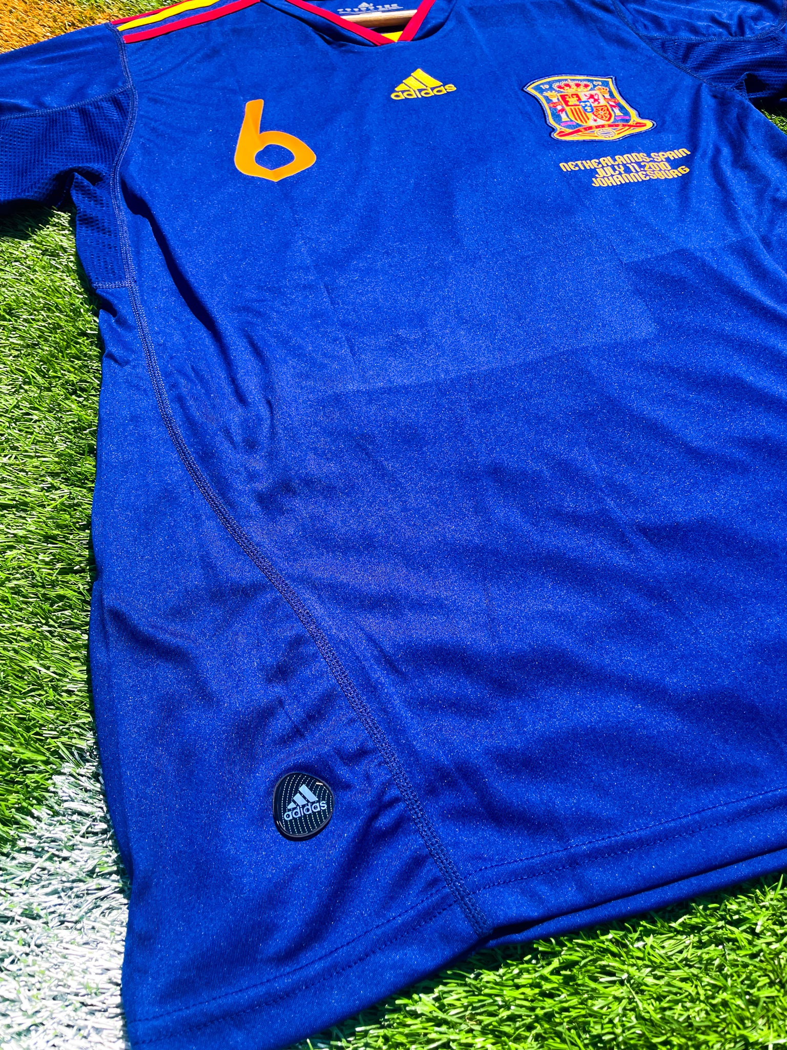 Detail shot of Spain crest and Adidas logo from 2010 Away kit

