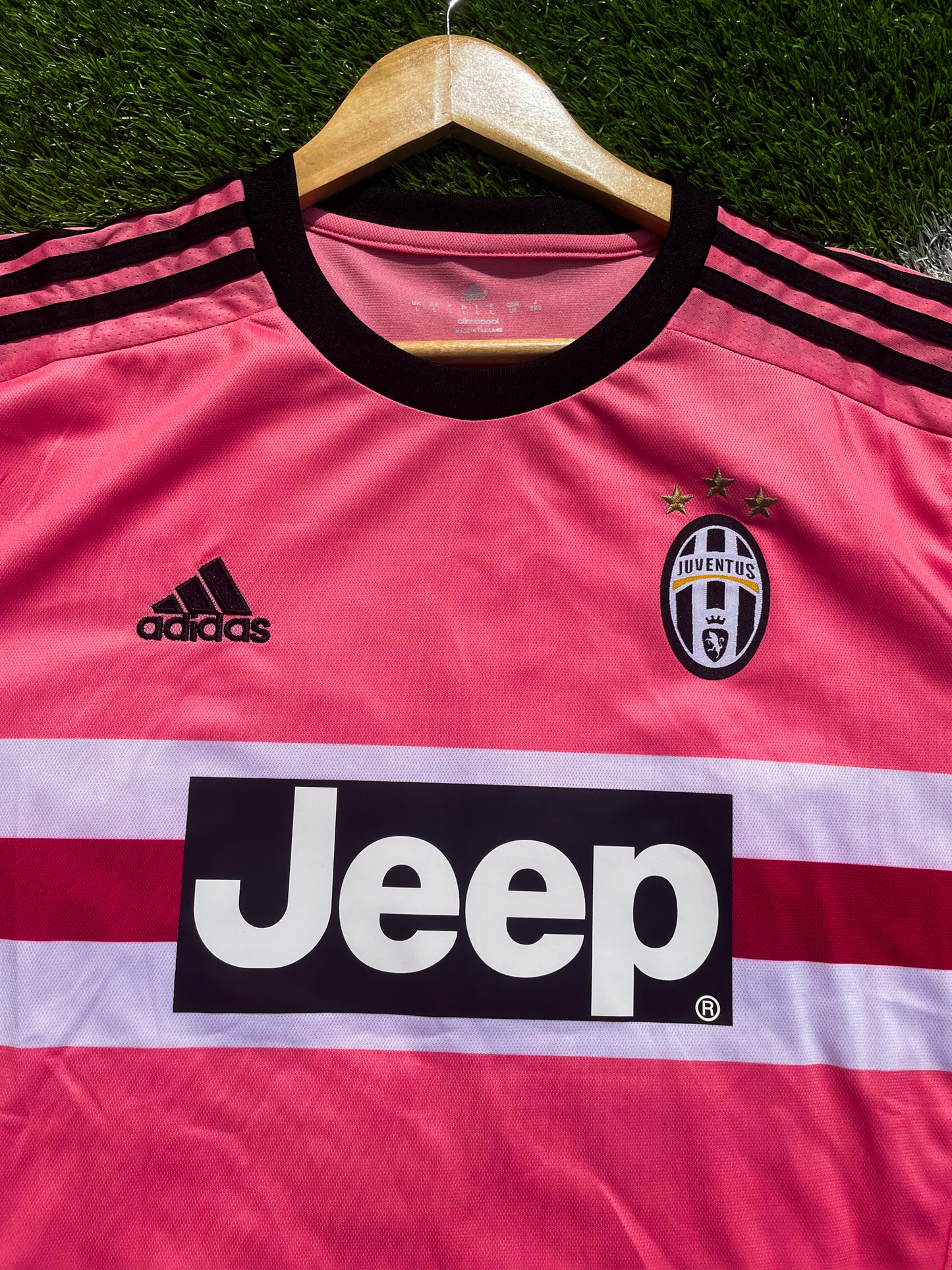 Close-up of Juventus crest, Adidas logo, and black trim

