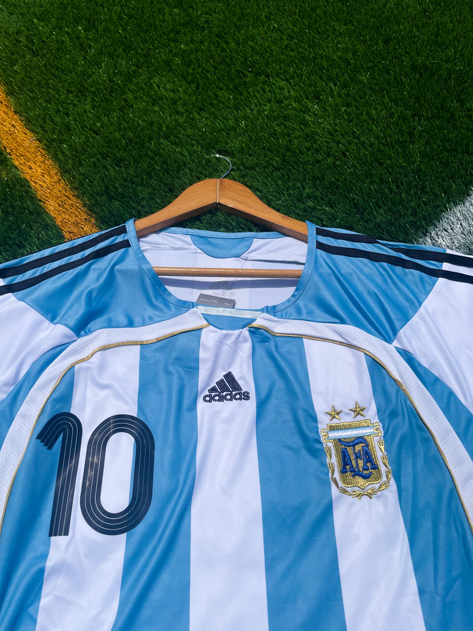 Detail shot of the jersey's fabric texture and gold accents.