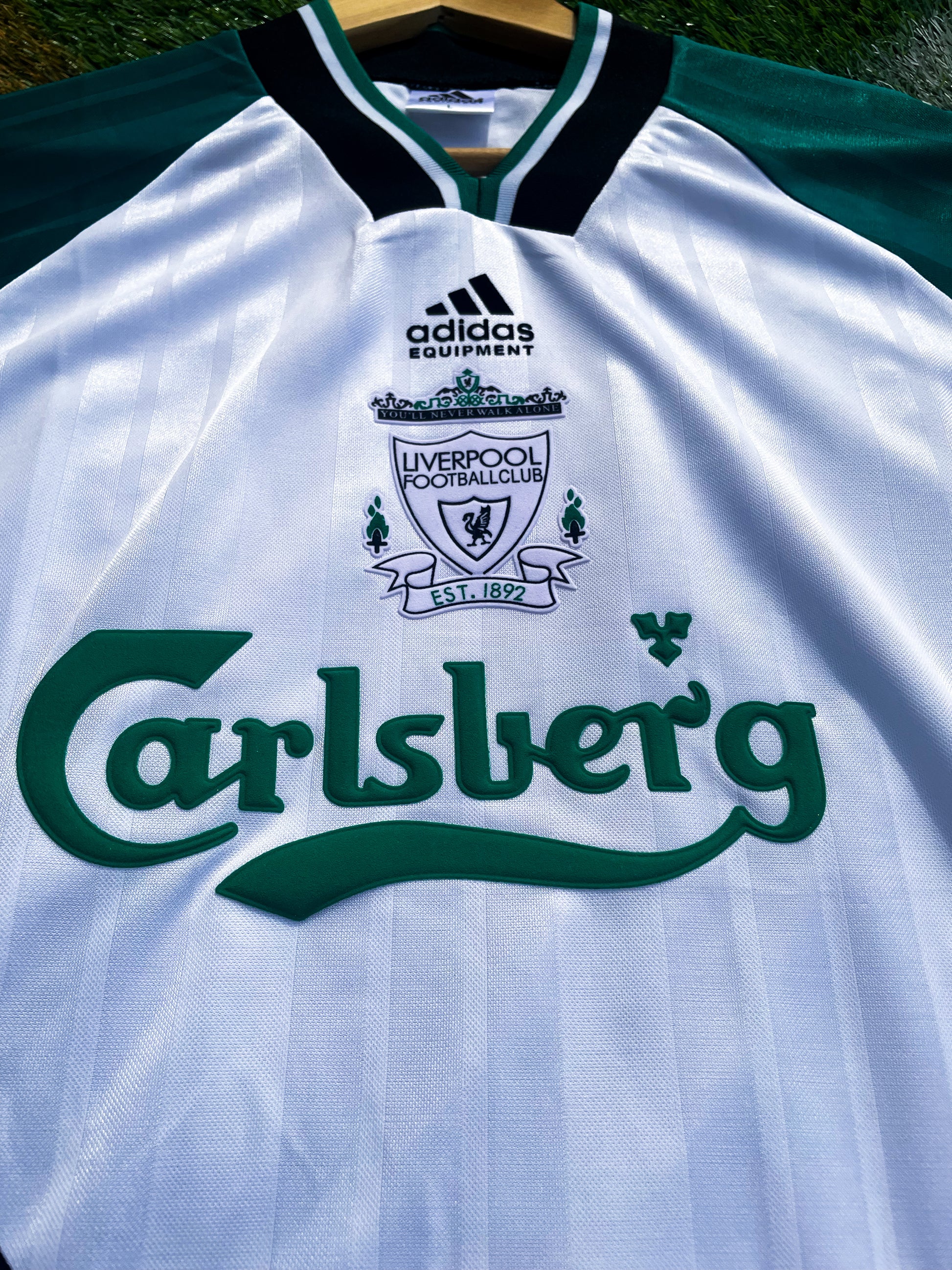 Close-up of retro Adidas logo and green detailing

