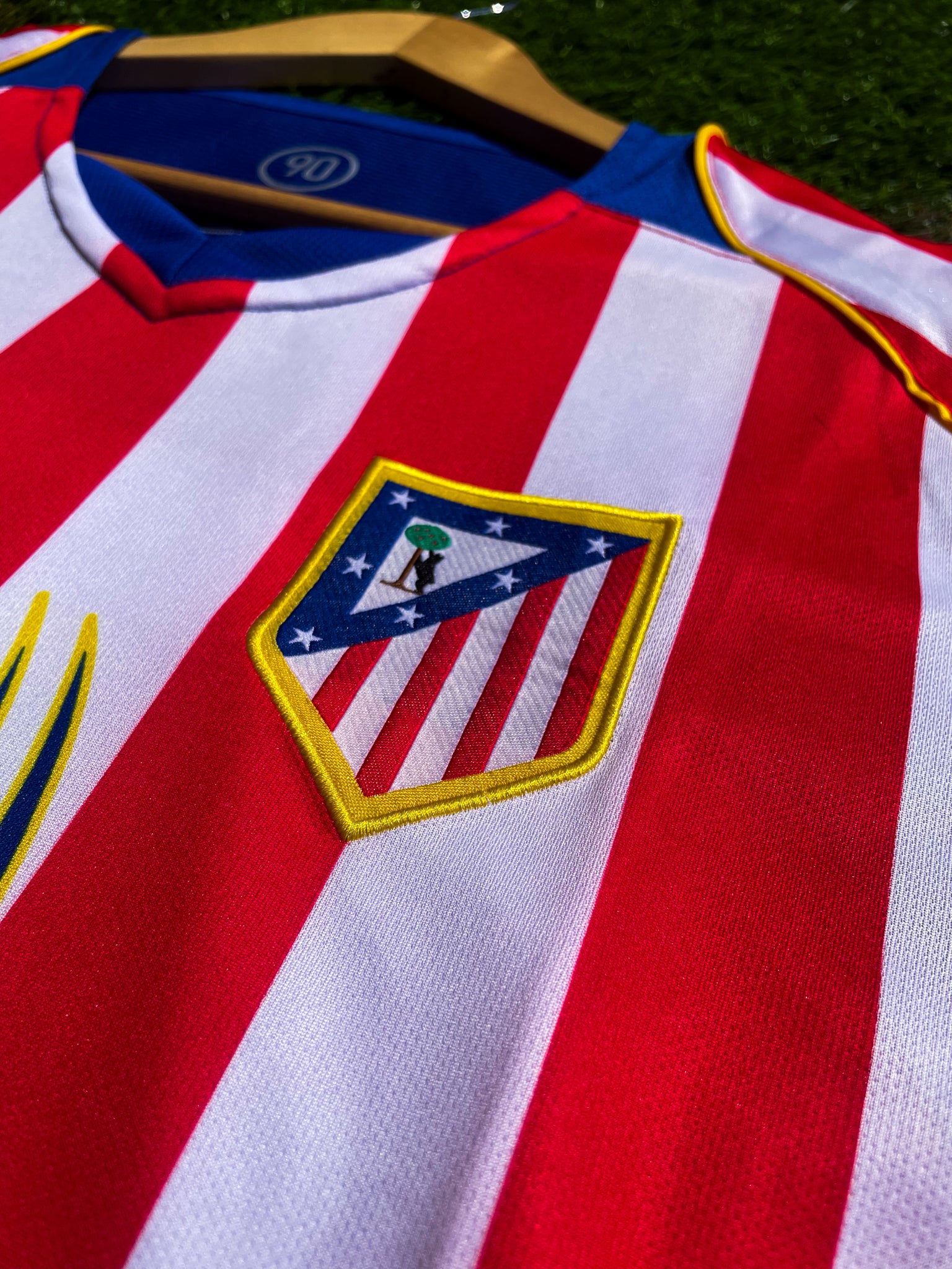 Close-up of Spiderman sponsor logo and embroidered club crest

