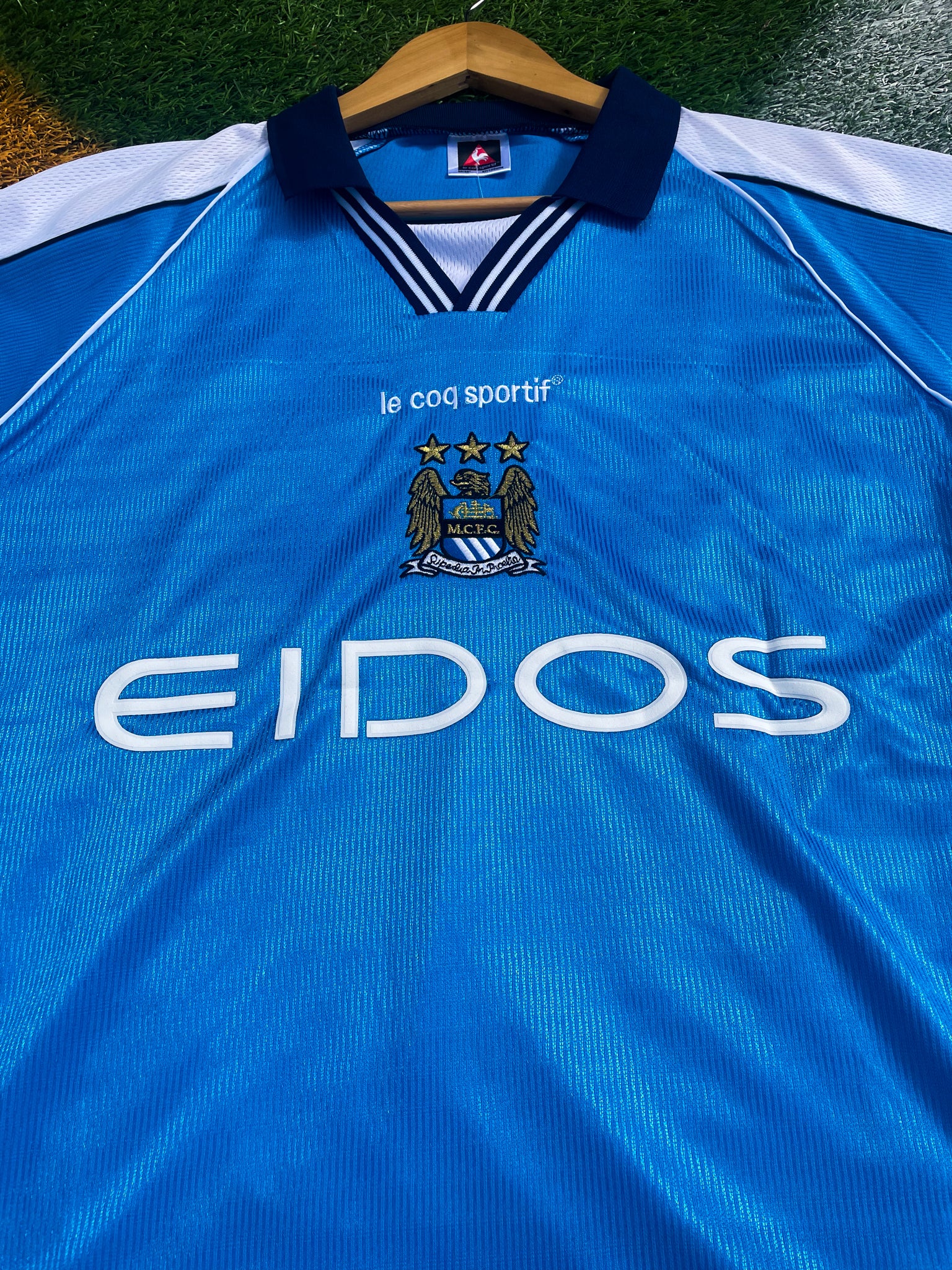 Close-up of sponsor logos and embroidered crest details

