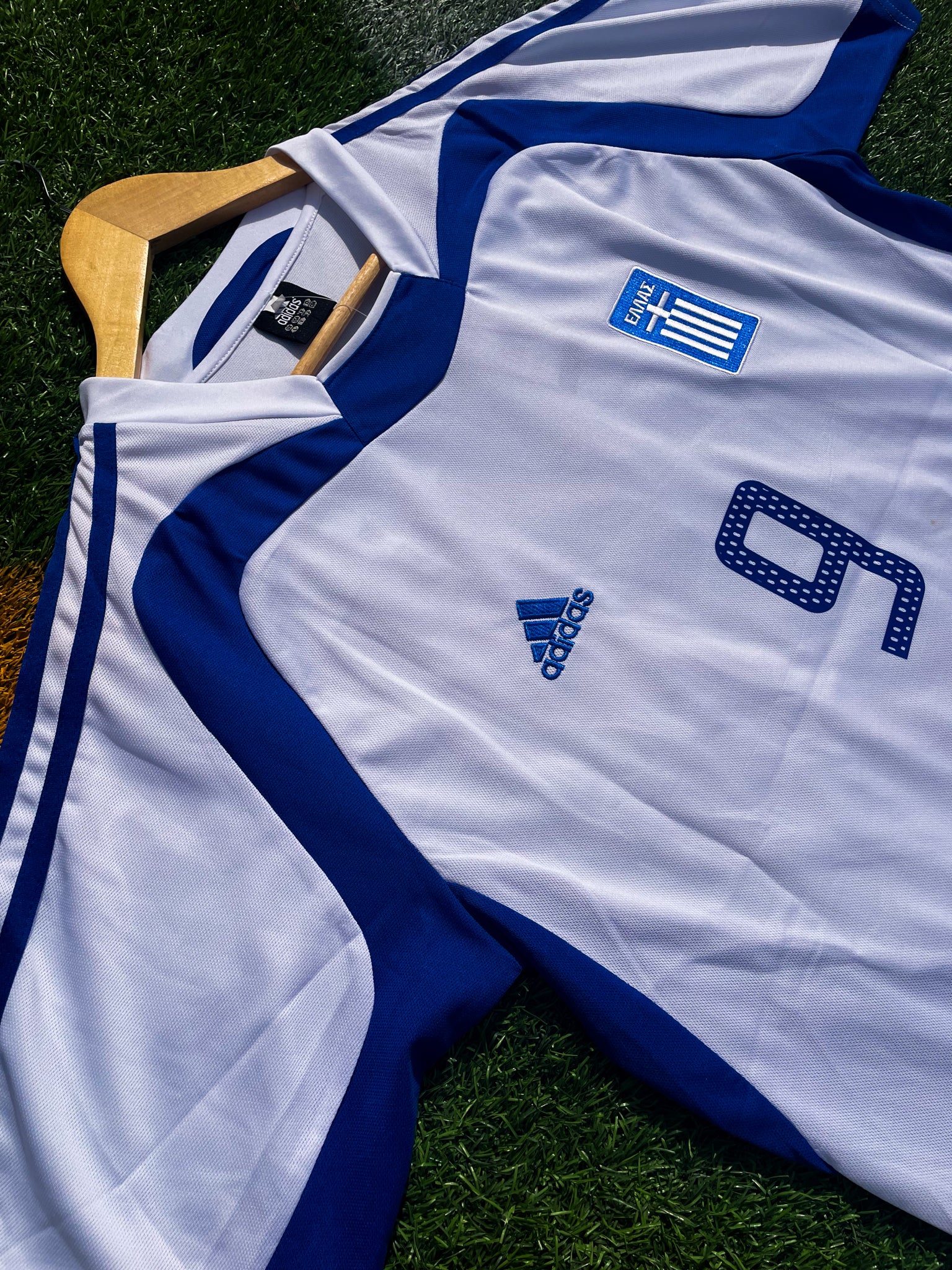 Close-up of Hellenic Federation crest and Adidas logo

