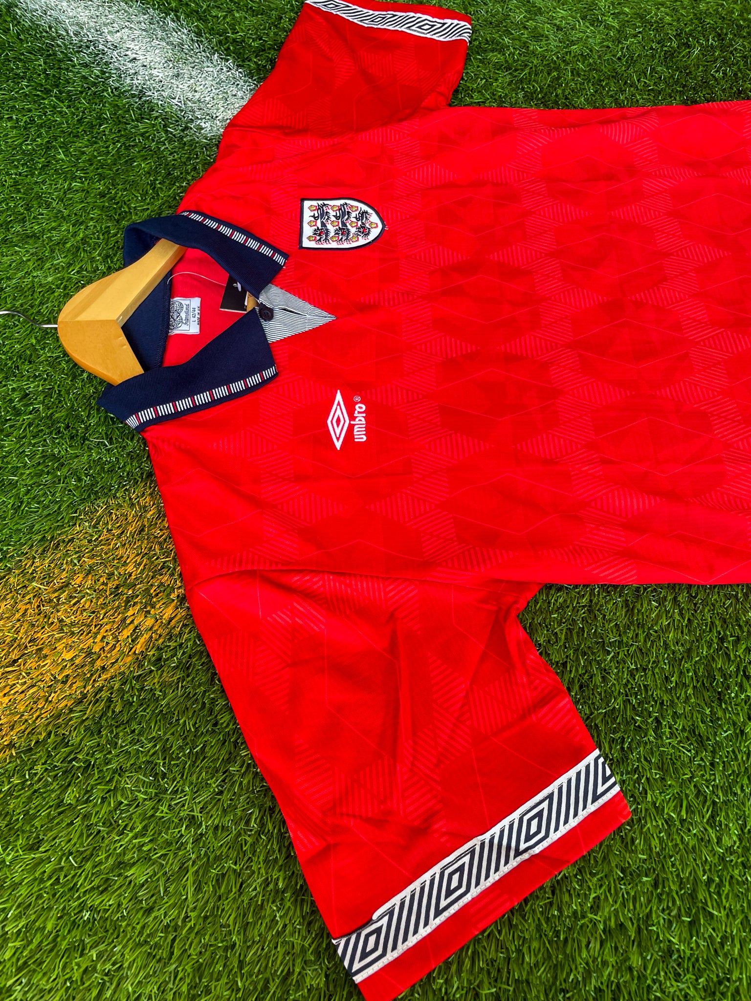 Close-up of Umbro logo and geometric pattern.

