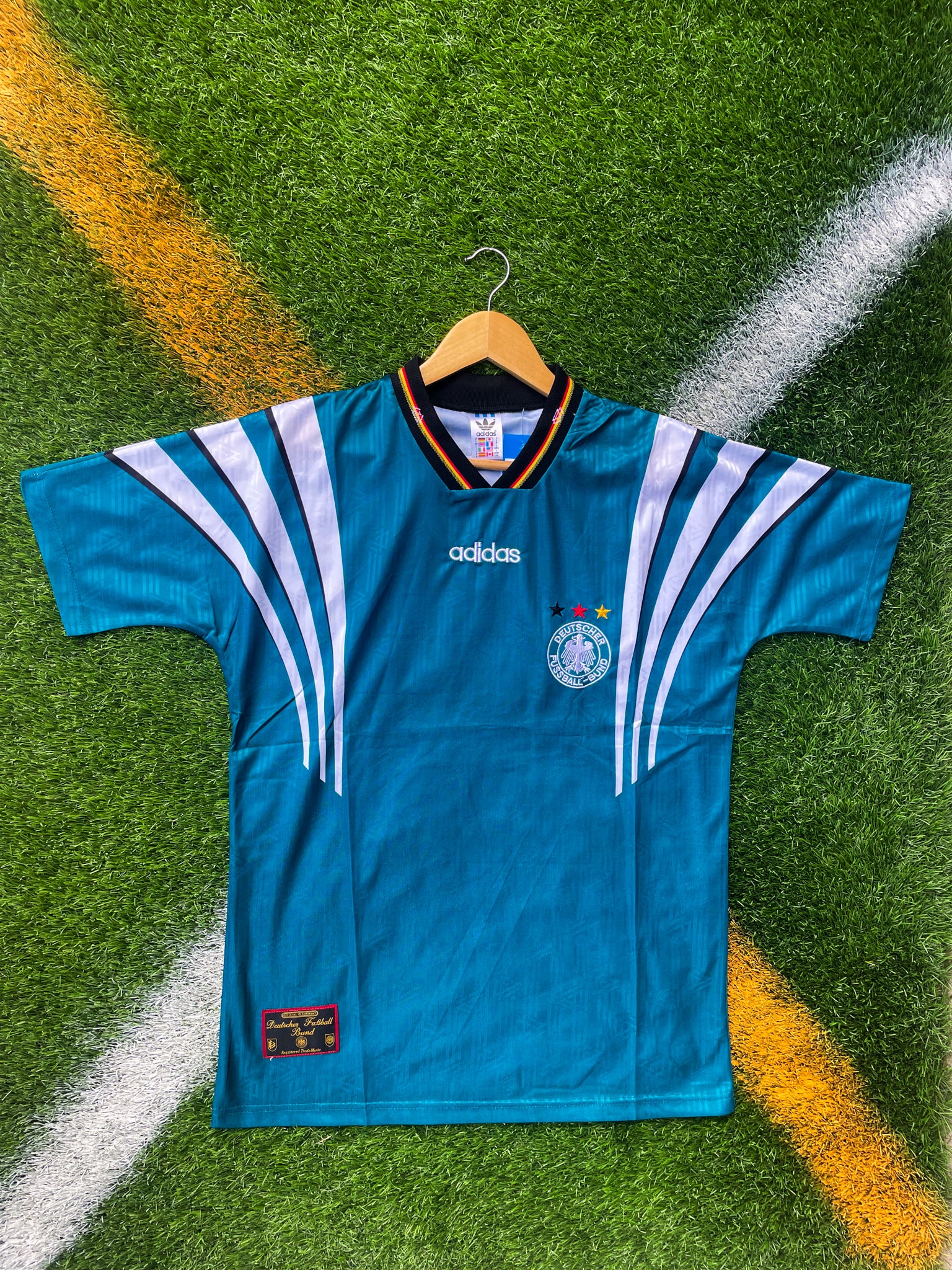 Front view of Germany 1996 away jersey in green with diamond pattern


