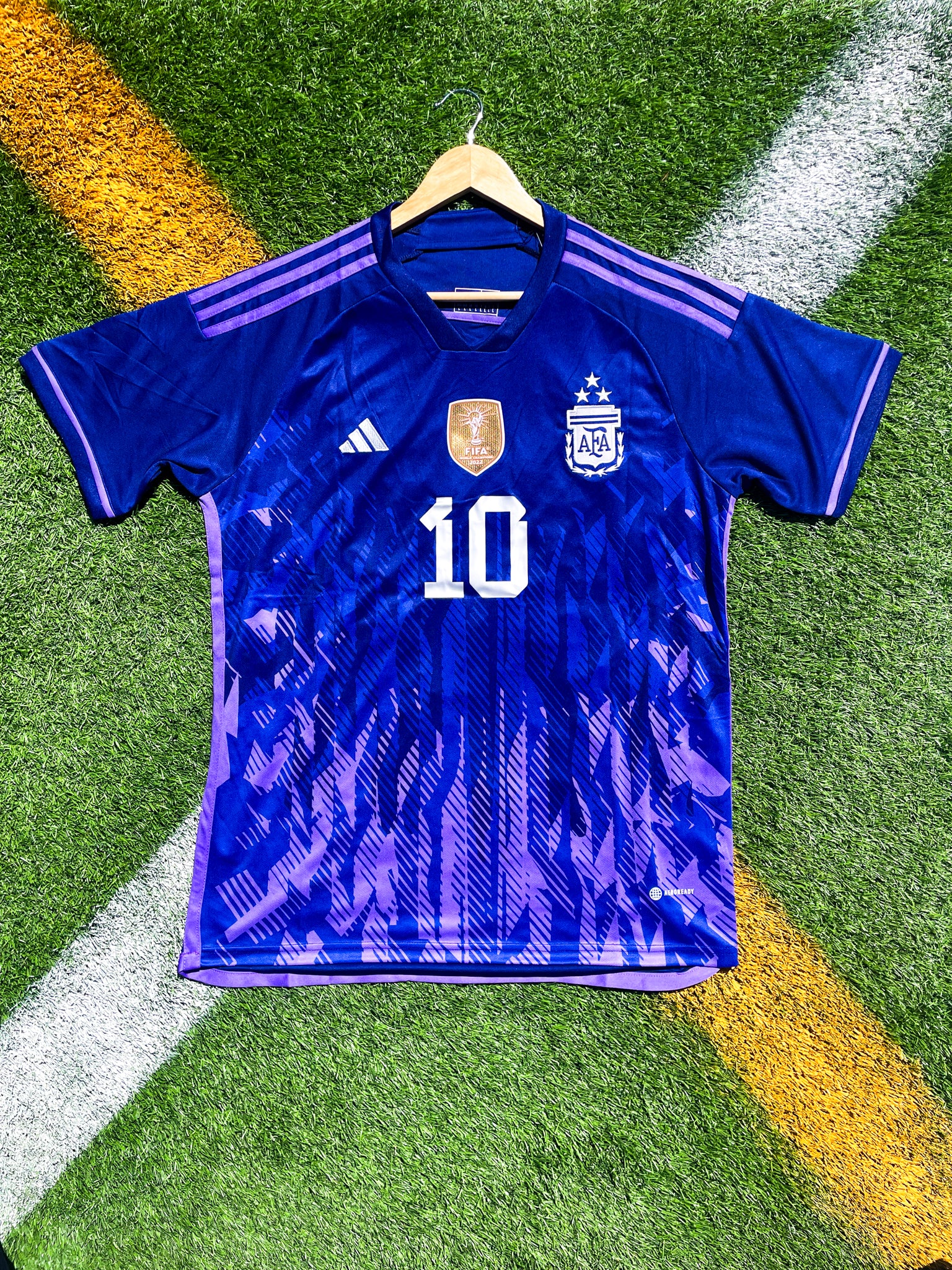 Front view of Argentina 2023 Away Jersey with Messi #10 and FIFA Champions badge.