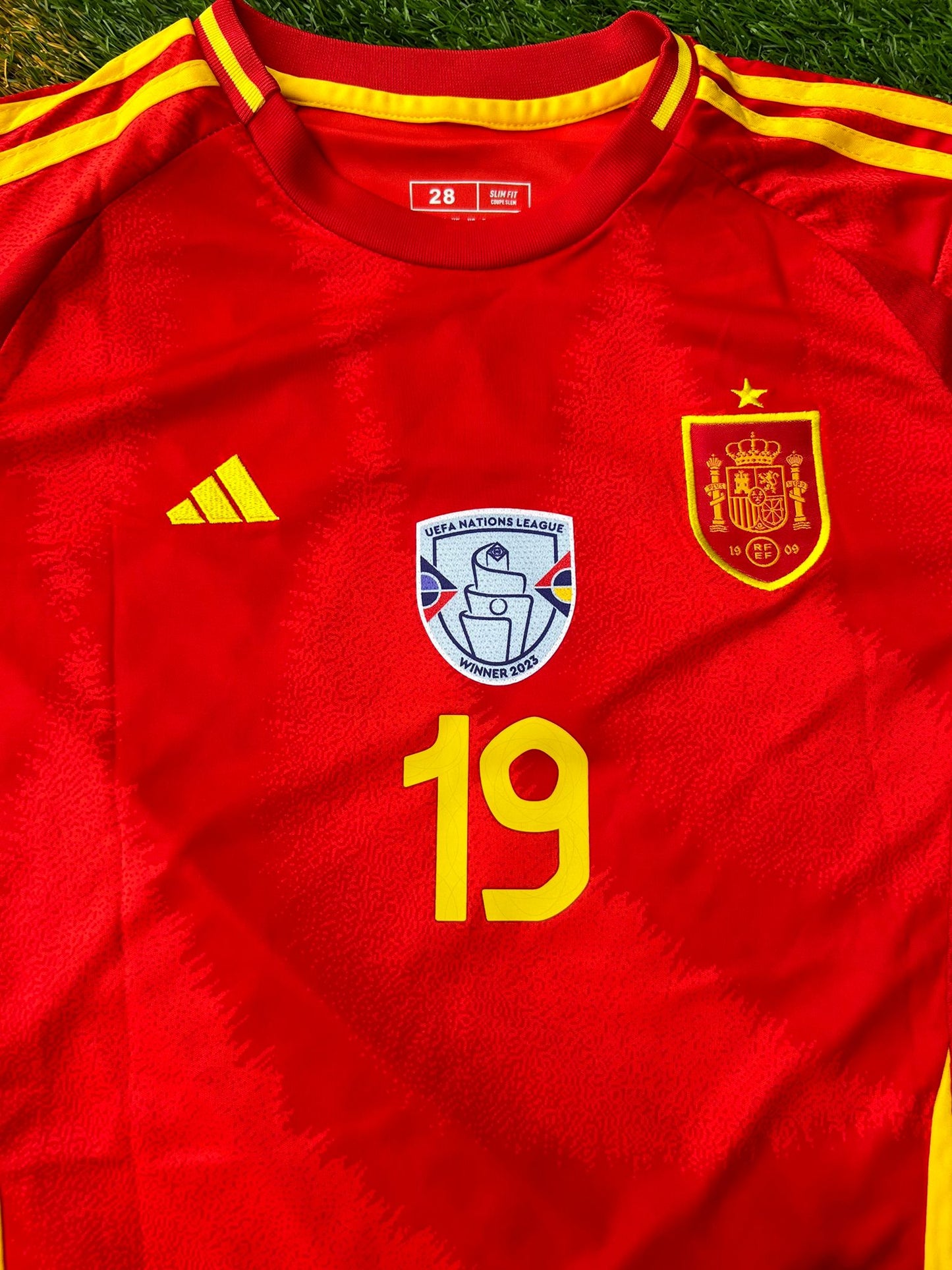 Close-up of RFEF crest and modern jersey texture

