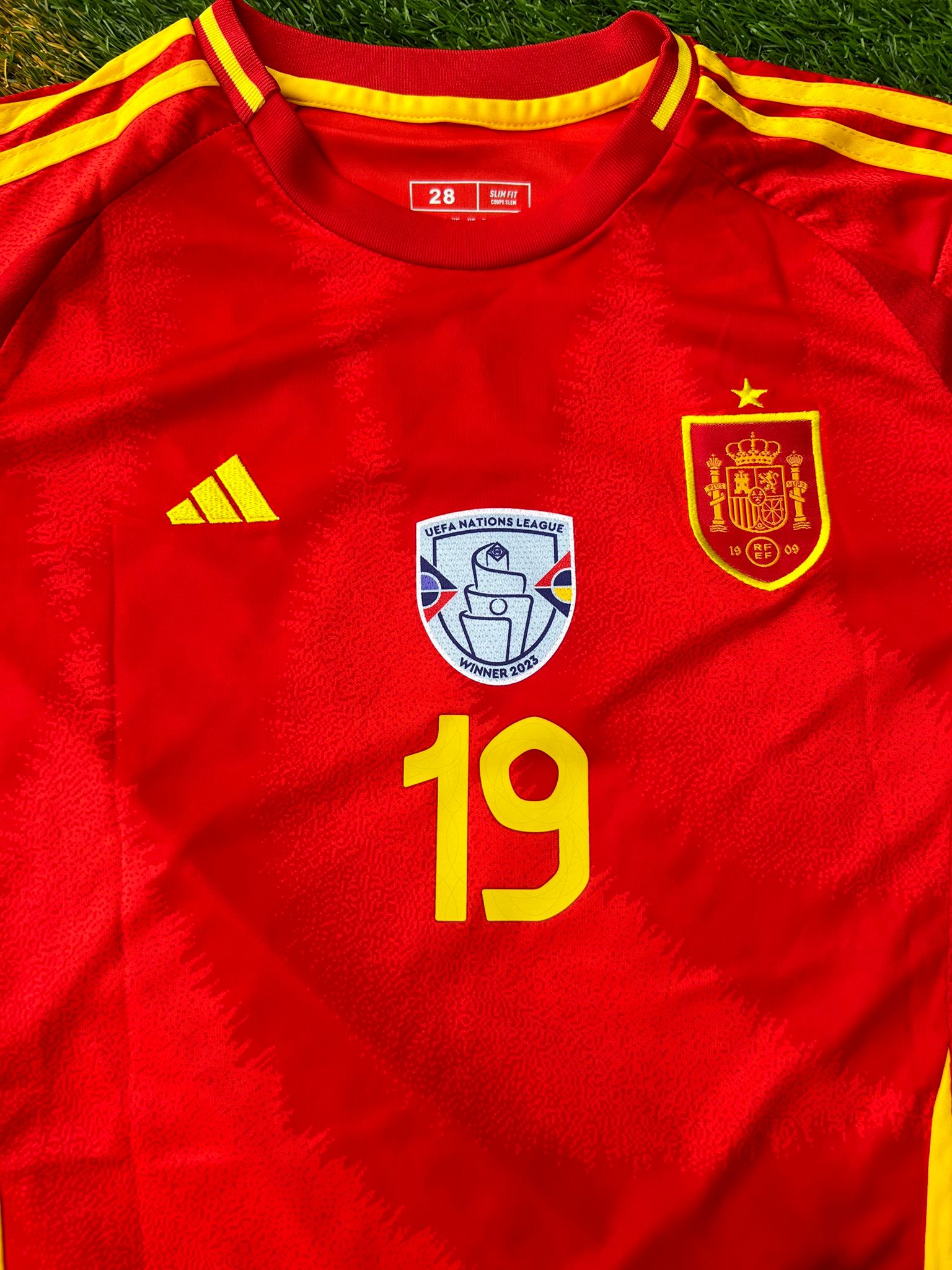 Close-up of RFEF crest and modern jersey texture


