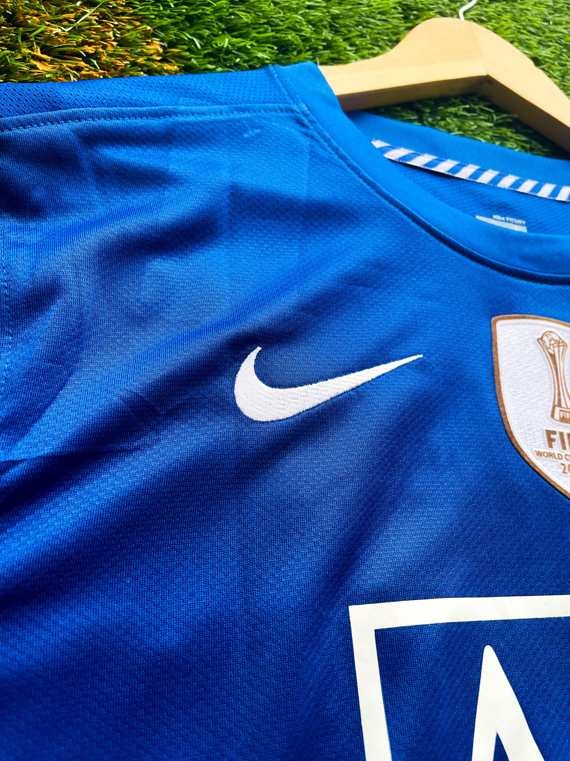 Close-up of Nike logo and Manchester United crest

