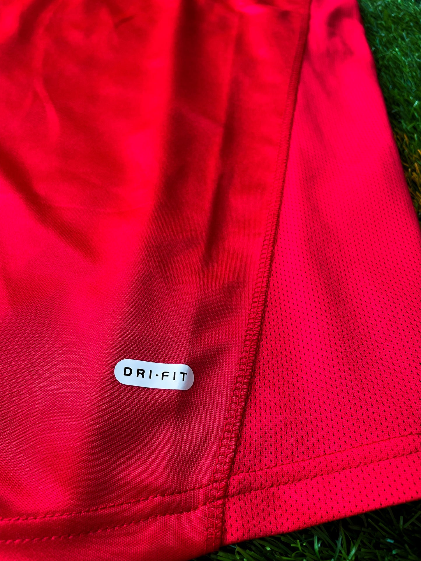 Close-up of Dreamcast sponsor and Nike swoosh on vintage Arsenal shirt

