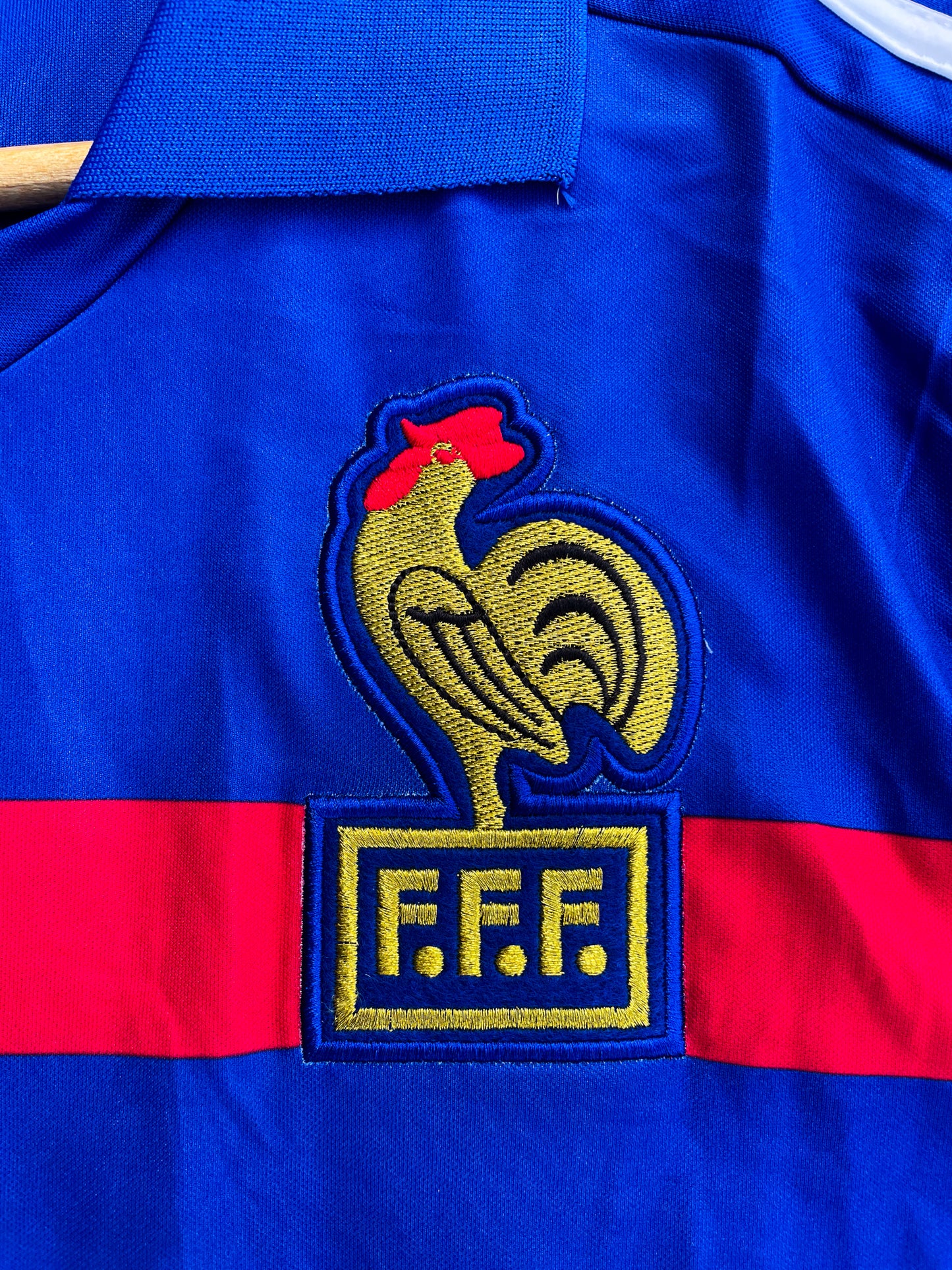 Close-up of FFF crest and Adidas trefoil on the jersey

