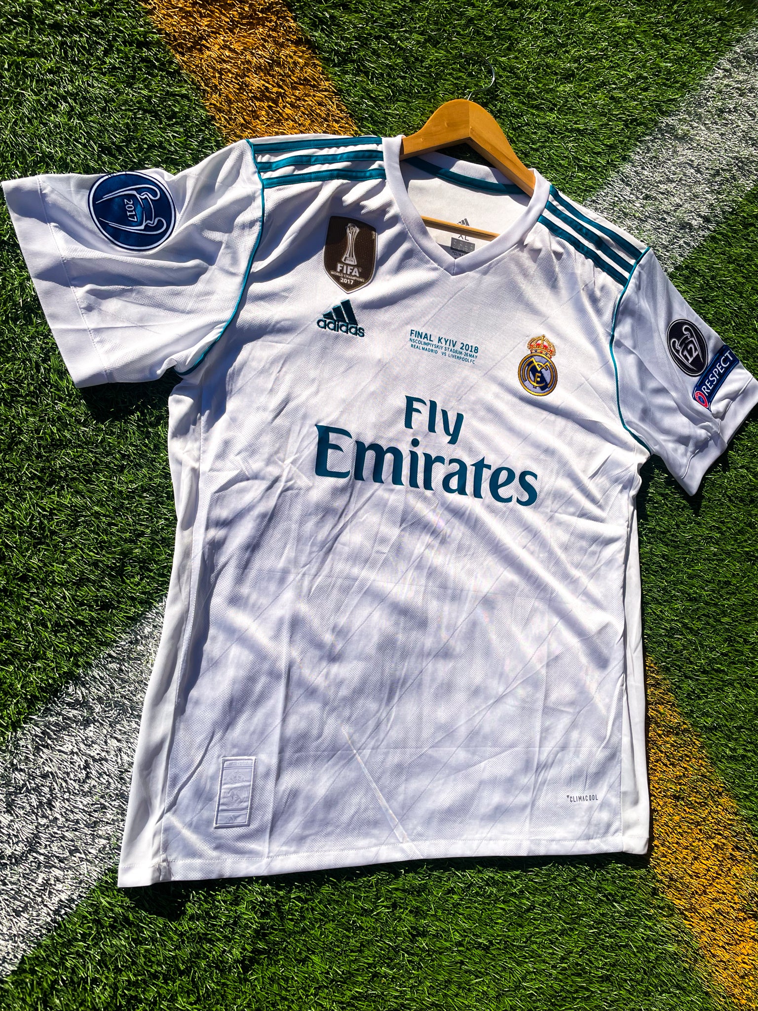 Close-up of embroidered club crest and Nike swoosh on white fabric

