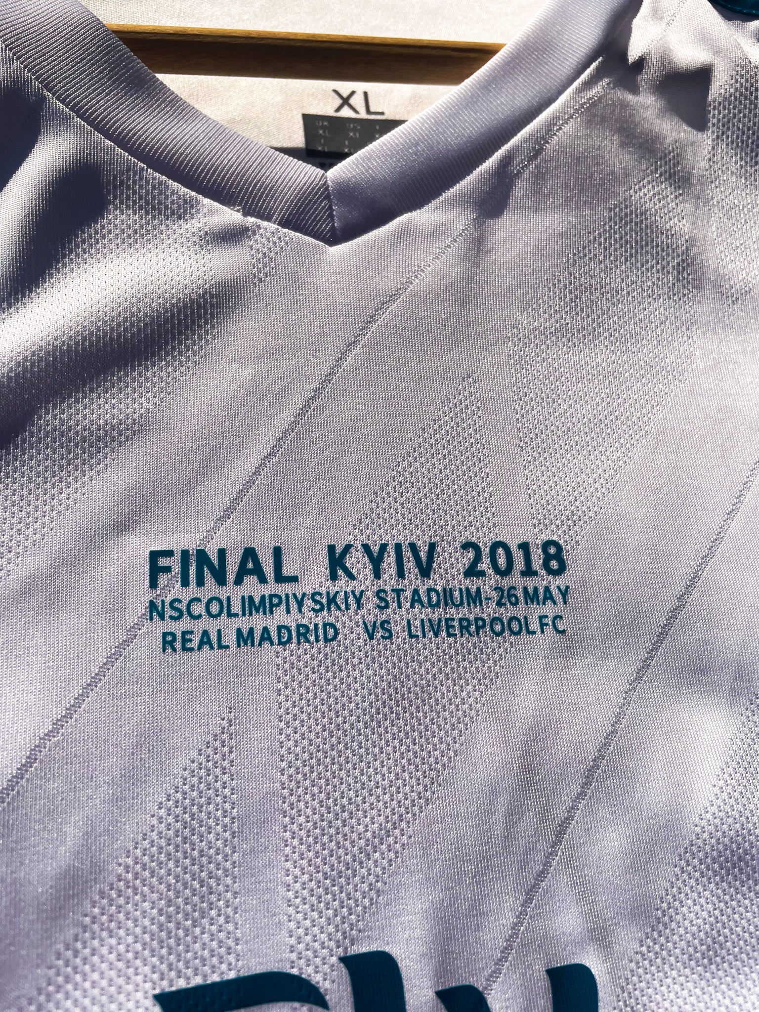 Close-up of embroidered club crest and Nike swoosh on white fabric

