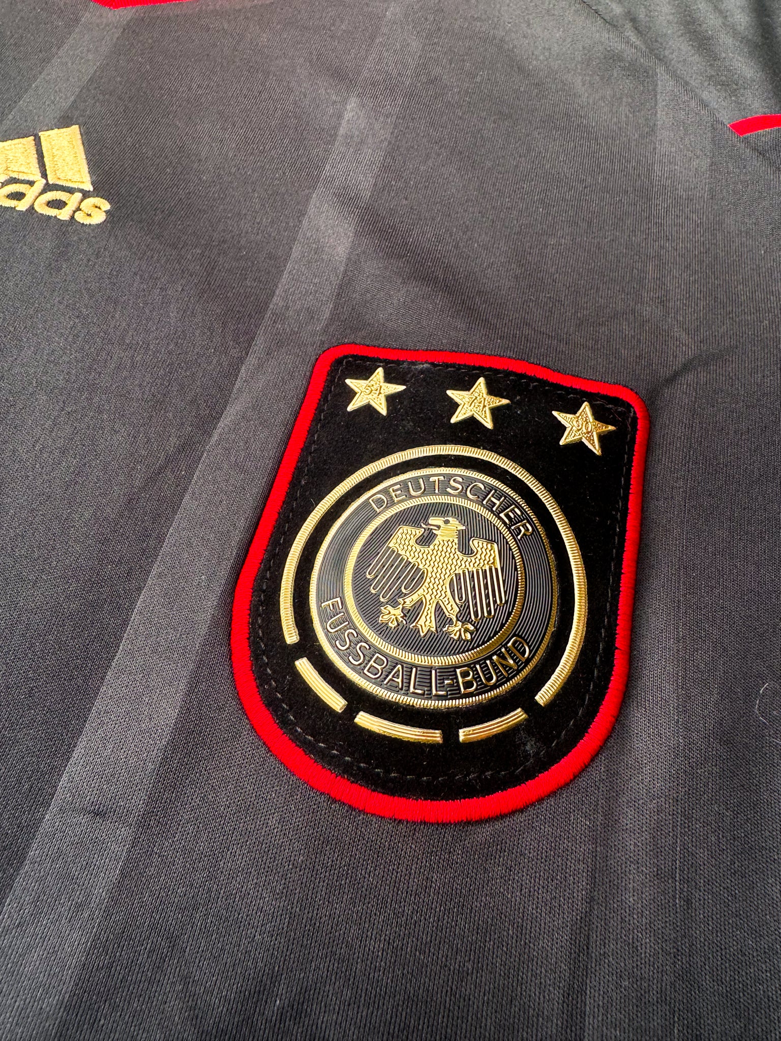 Close-up of Adidas logo and DFB crest

