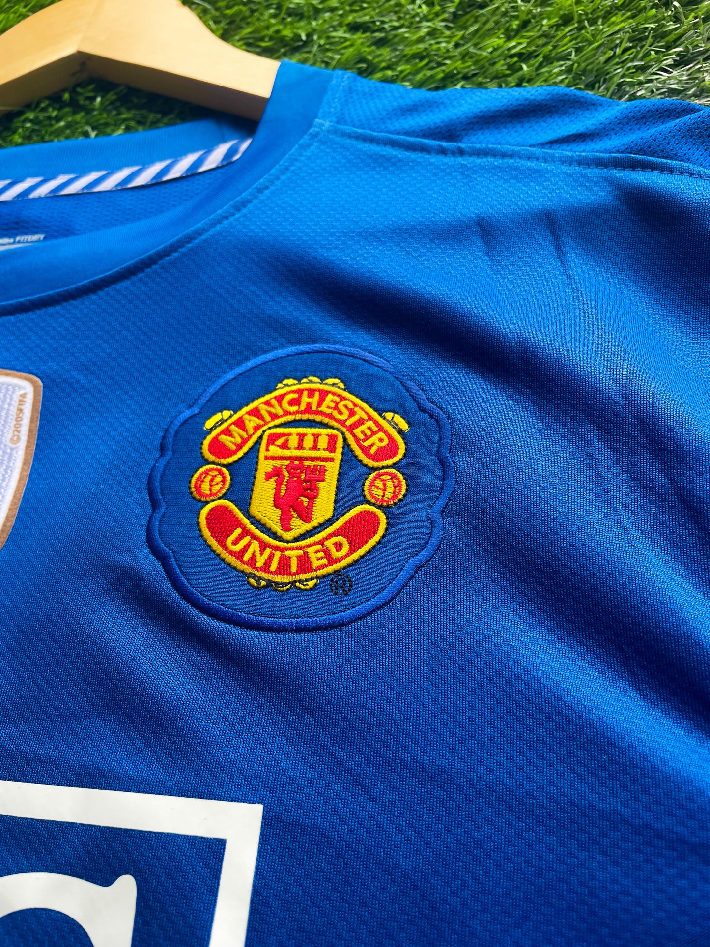 Close-up of Nike logo and Manchester United crest

