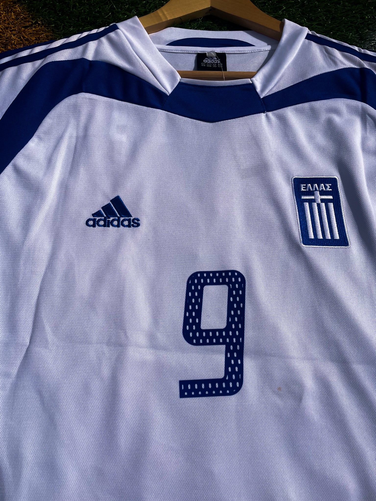 Close-up of Hellenic Federation crest and Adidas logo

