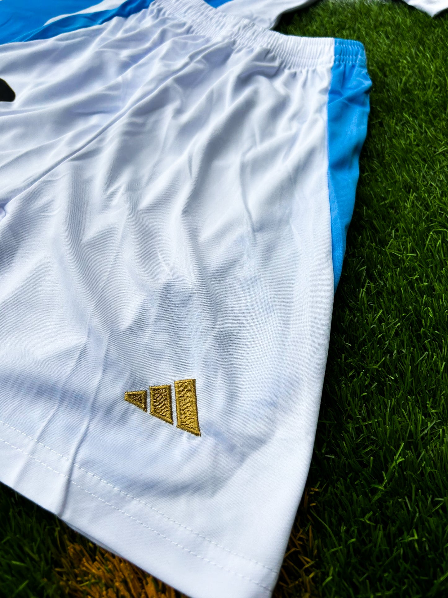 Detail shot of fabric texture and updated 2024 design elements on the kids' shorts. 